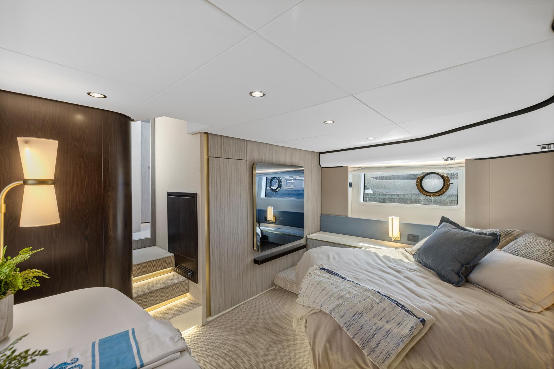 Luxurious interior of 2019 Azimut 55 yacht, featuring elegant bedroom design and modern lighting.