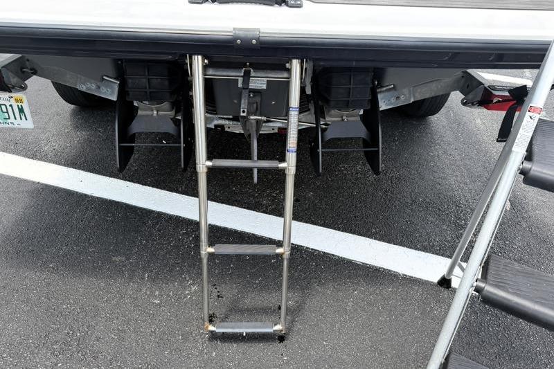 2017 Yamaha Boats SX210 with extended swim ladder on asphalt surface.
