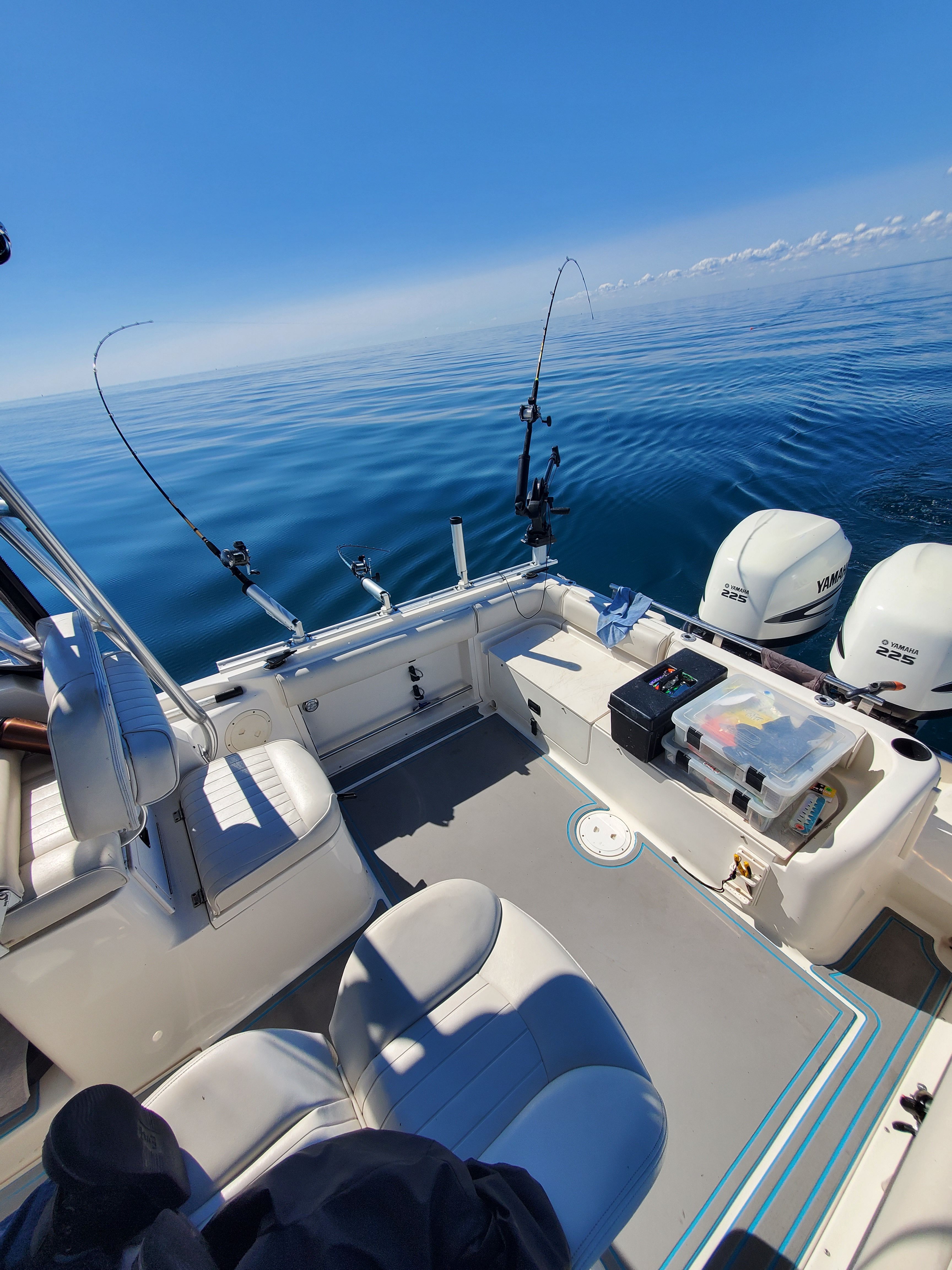 2005 Robalo R265 Walkaround on calm sea with fishing rods.