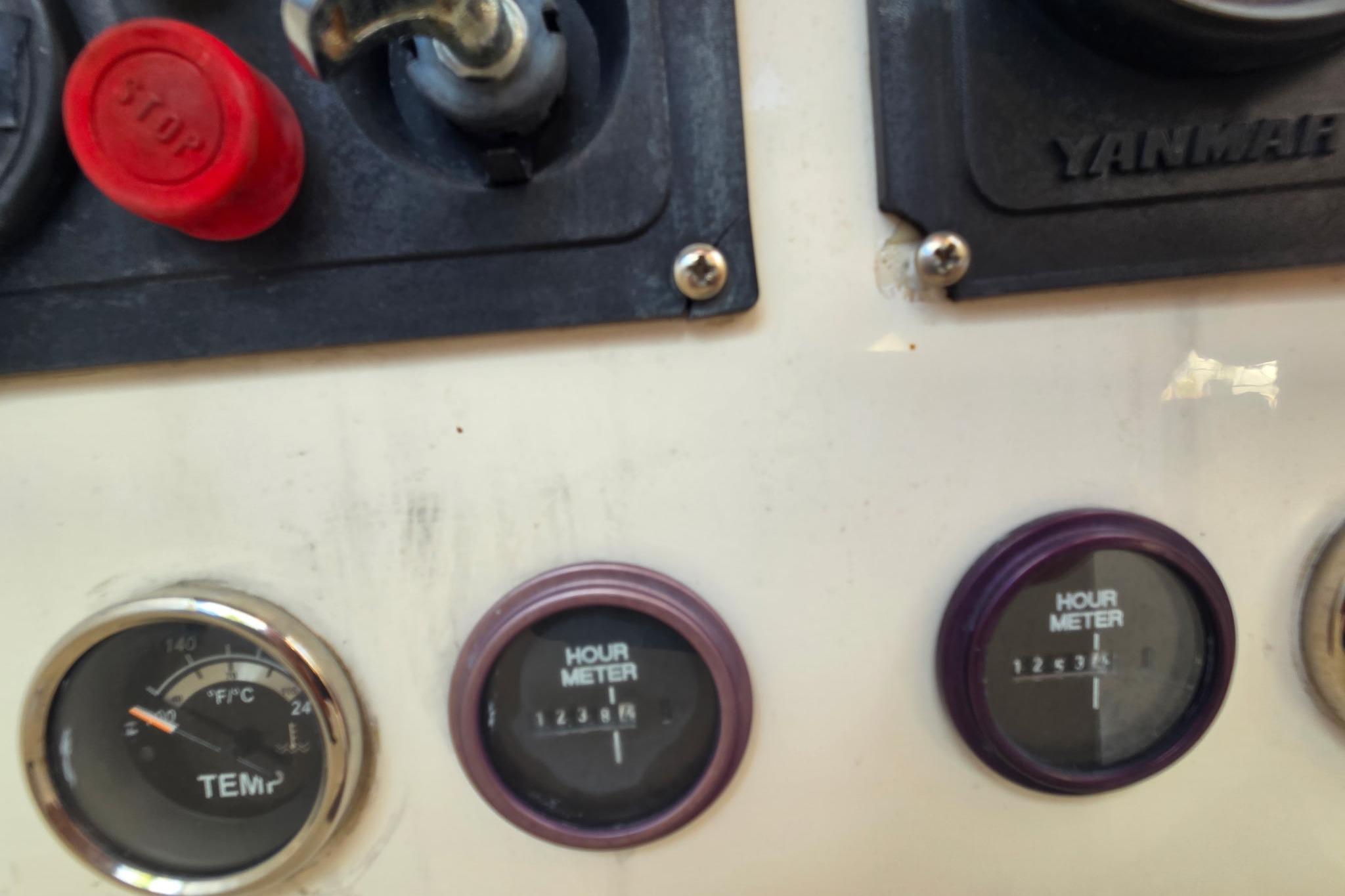 Control panel of a 2000 Fountaine Pajot Maryland 37 with gauges and hour meters.