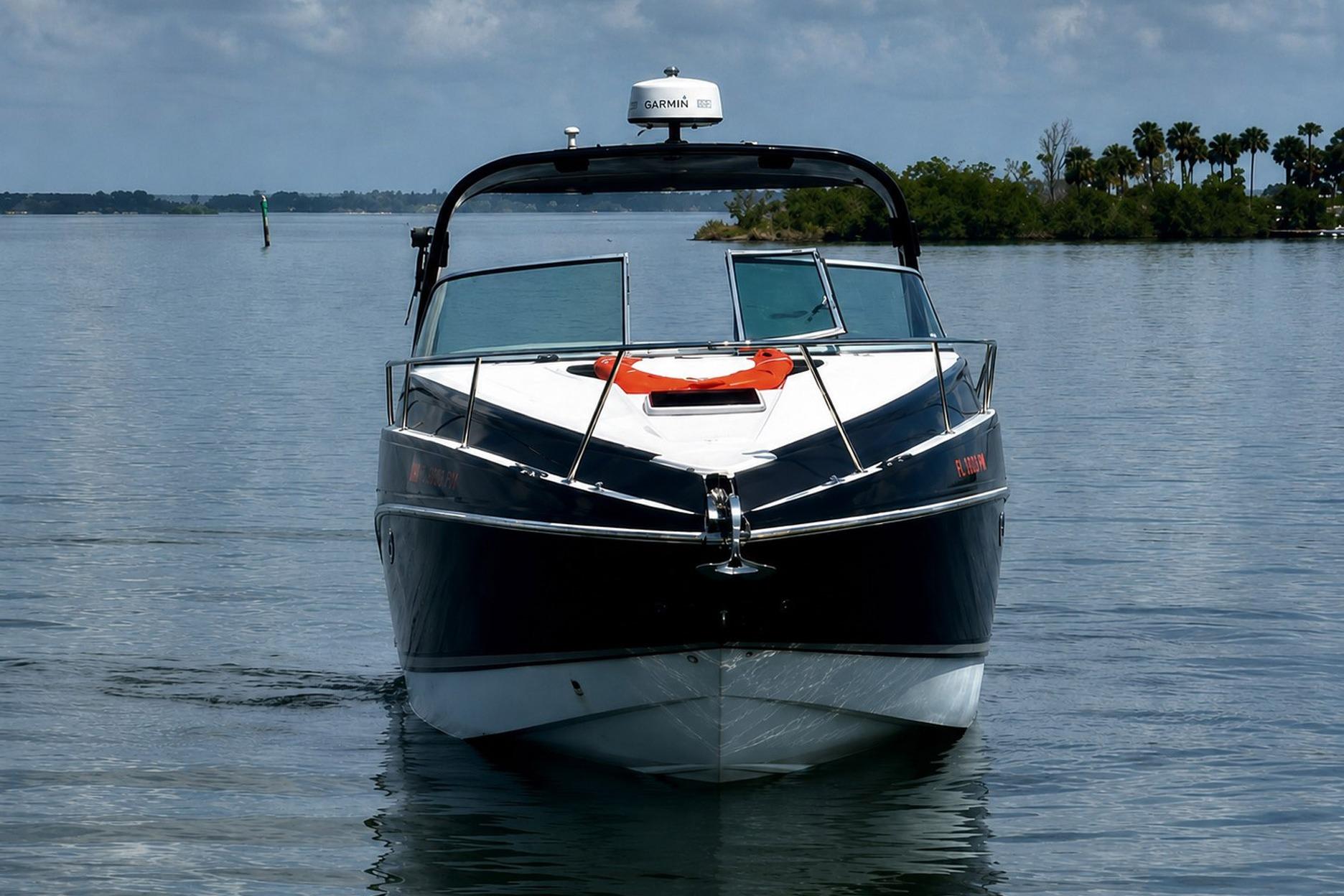 2012 Rinker 310 Express Cruiser LE on calm water, front view.