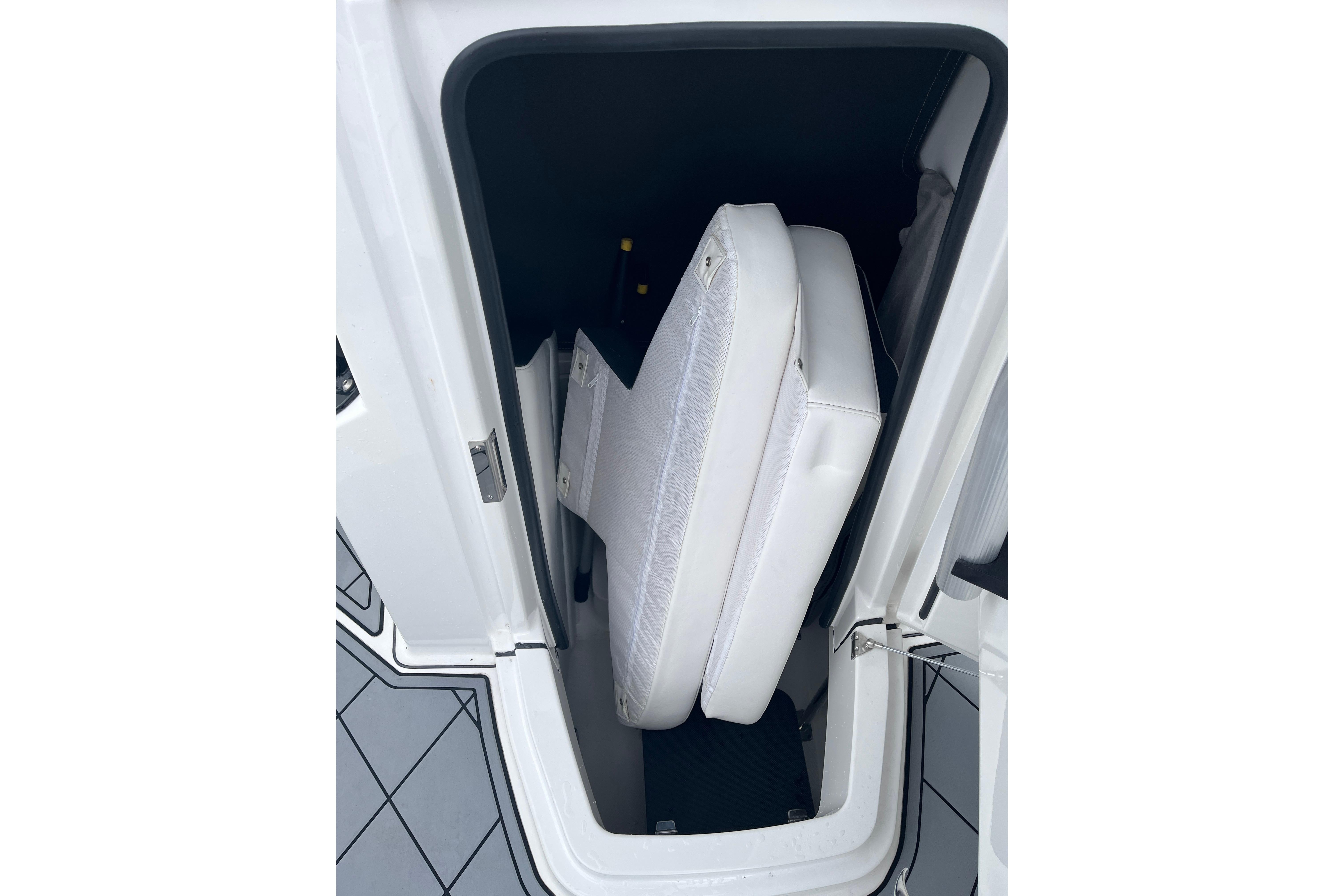 Storage compartment with cushions in a 2021 Blackfin 252 CC boat.