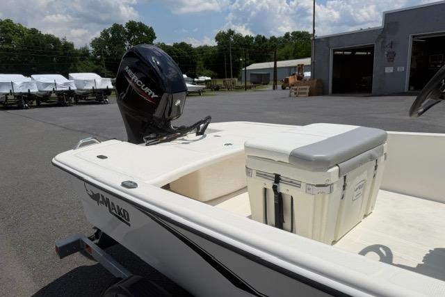 2025 Mako Pro Skiff 17 CC boat with Mercury engine, parked outdoors.