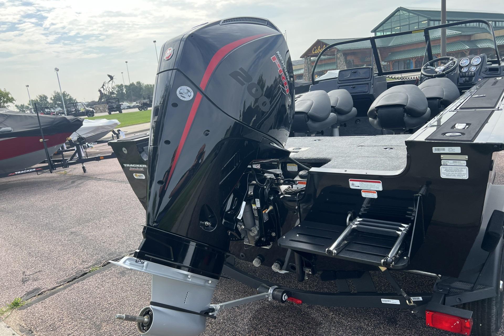 2025 Tracker Targa V-18 Combo boat with powerful outboard motor, parked outdoors.