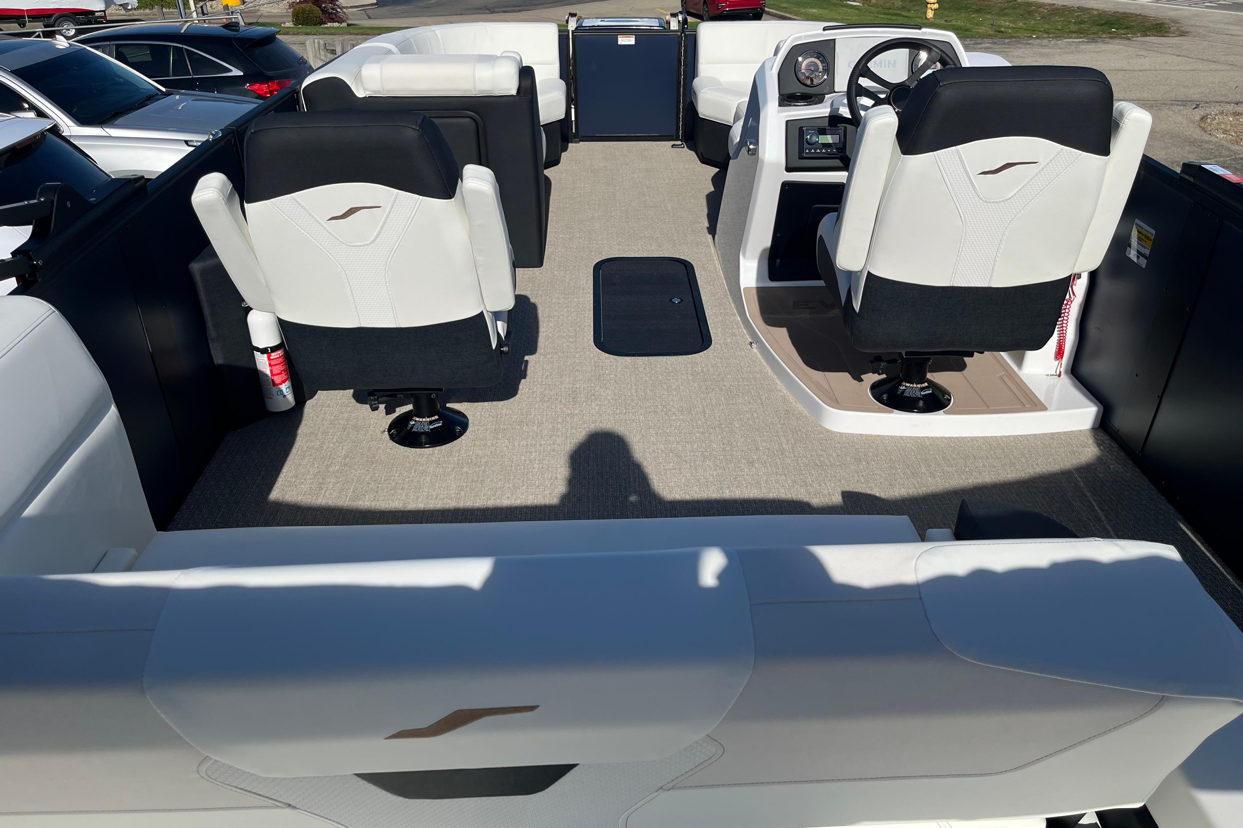 Interior of 2026 Evotti 523CS boat with modern seating and steering console.