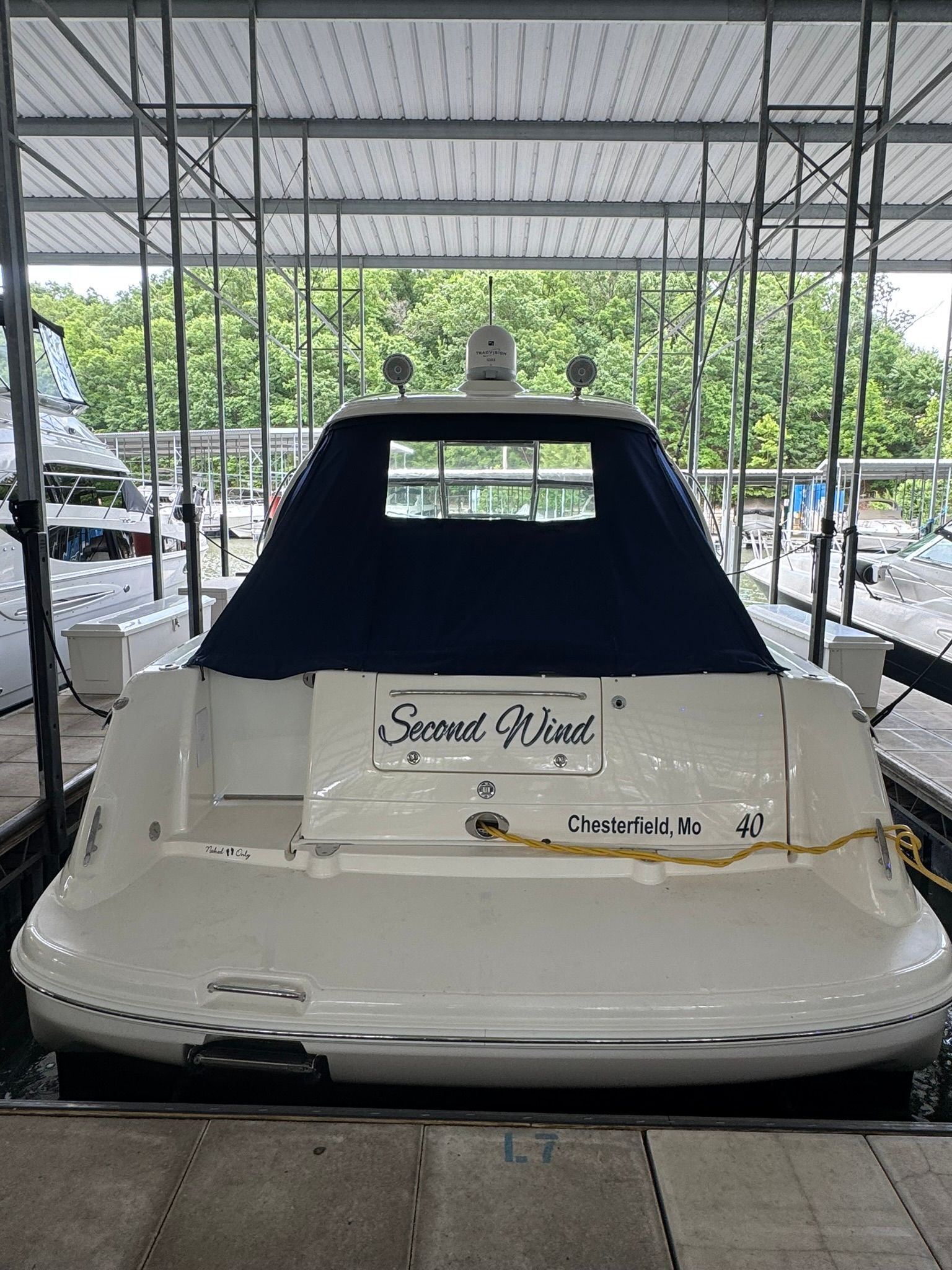 Rear view of a 2007 Sea Ray 40 Sundancer docked in a marina.