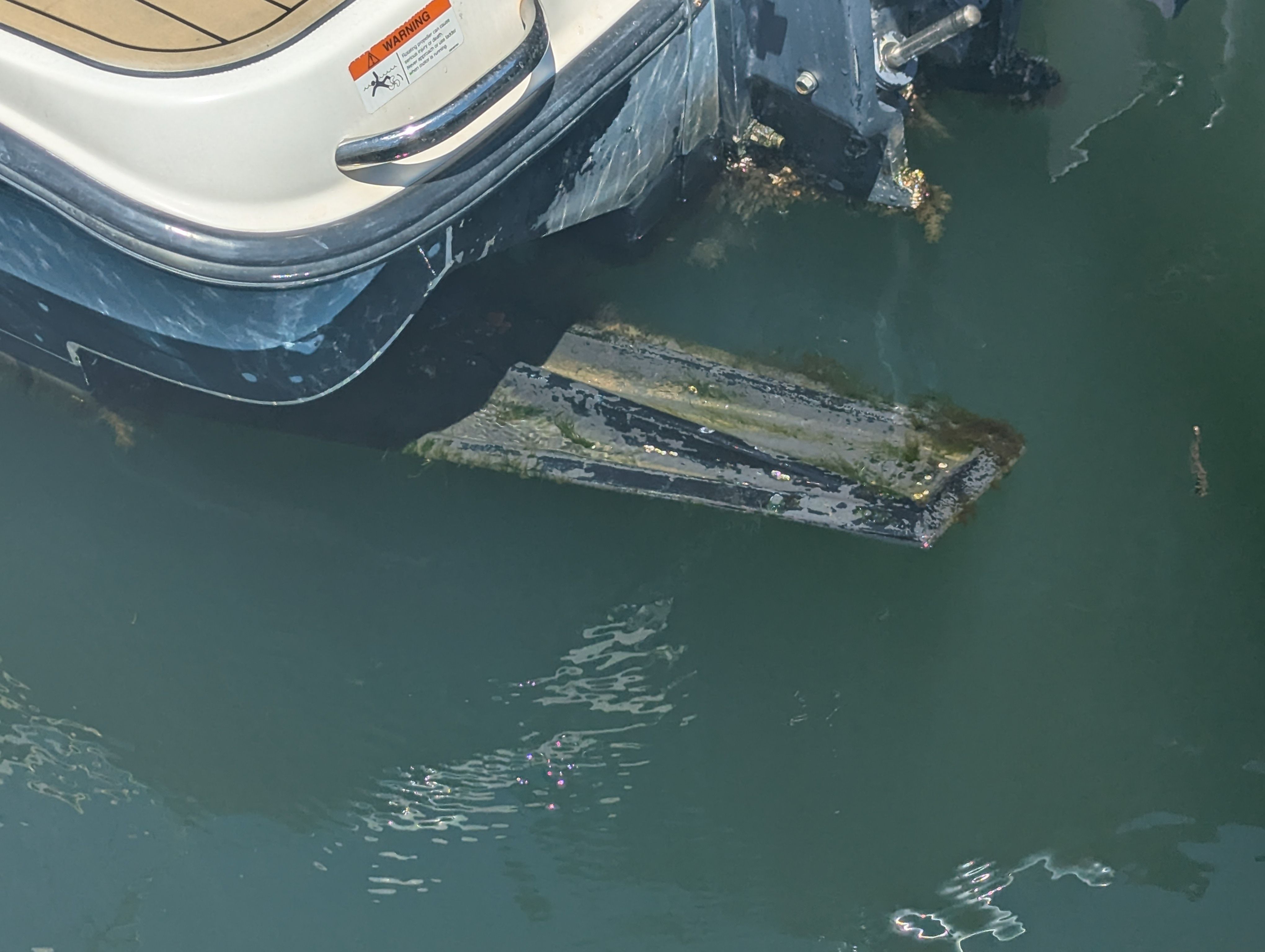 Rear of a 2005 Wellcraft 35 CCF boat in water.