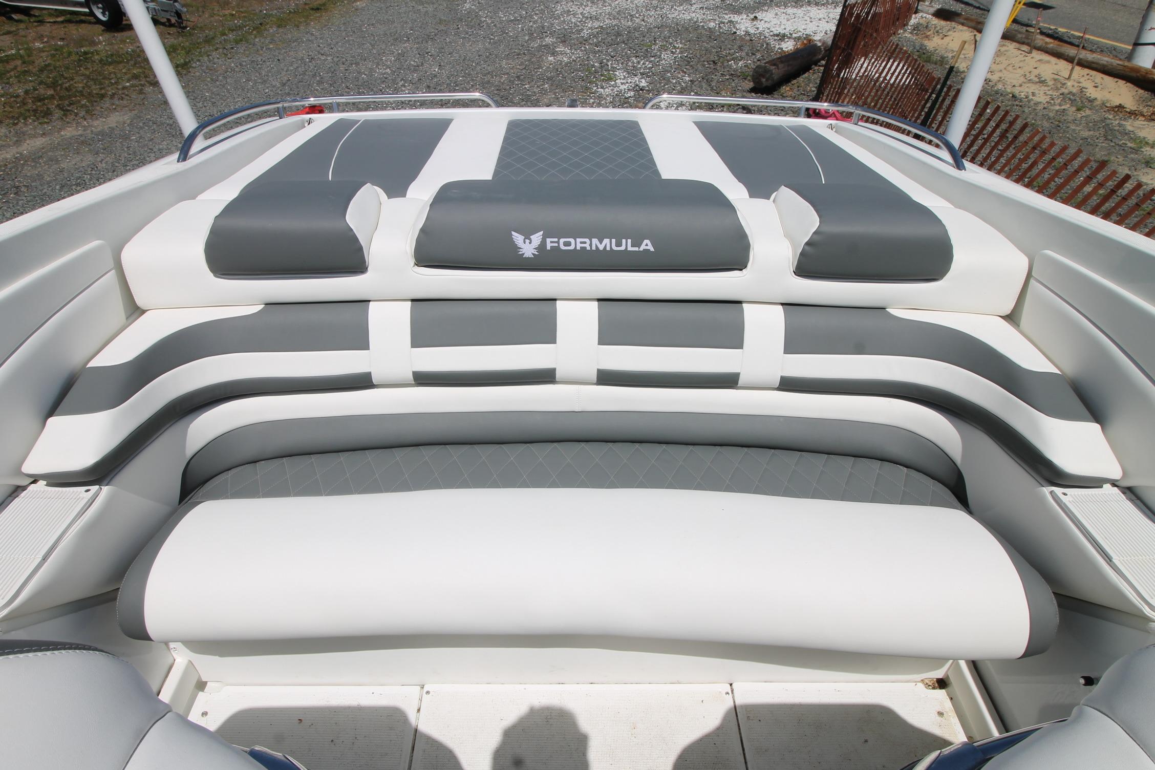 2006 Formula 292 FASTech boat interior with gray and white cushioned seating.