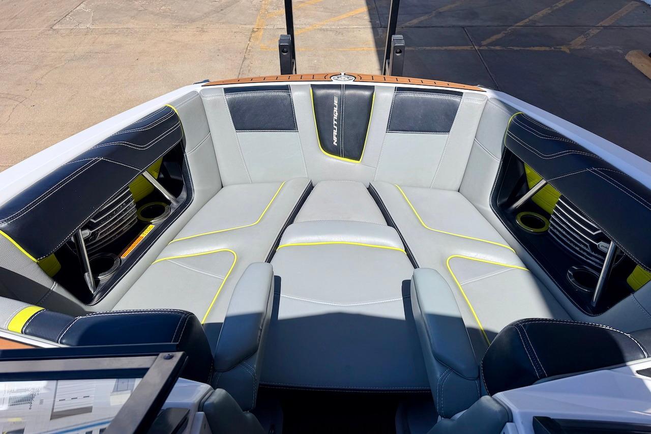 2014 Nautique Super Air Nautique G21 boat interior with stylish seating and cup holders.