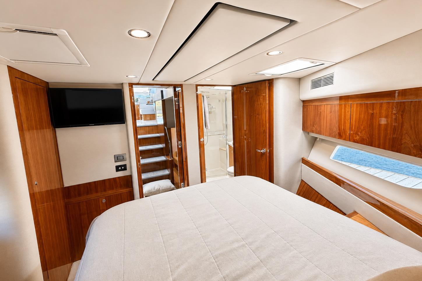 Luxurious interior of 2021 Riviera 575 SUV yacht with wood accents and modern amenities.