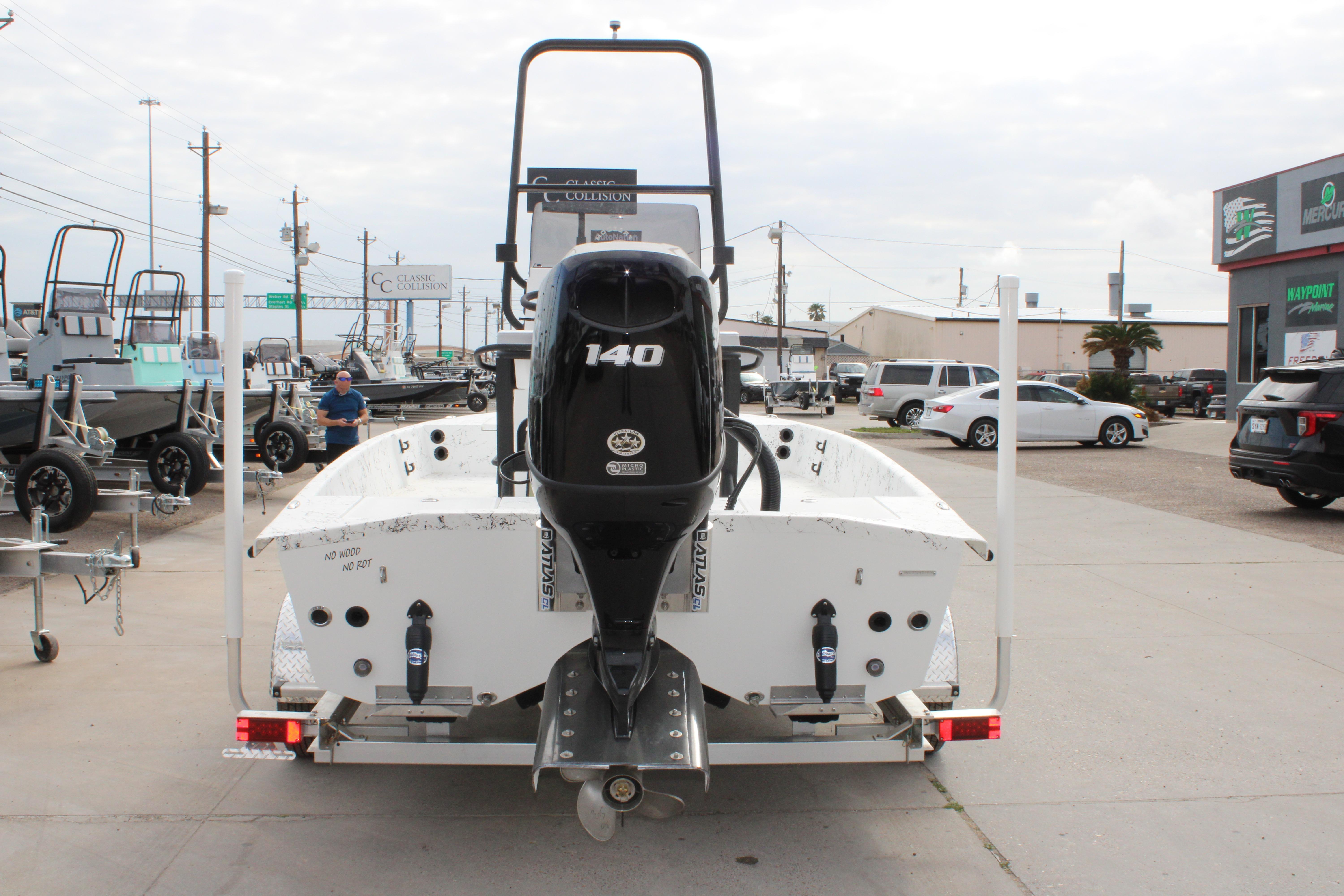 2026 Freedom Boats 19 PATRIOT with 140 HP engine on trailer in dealership lot.