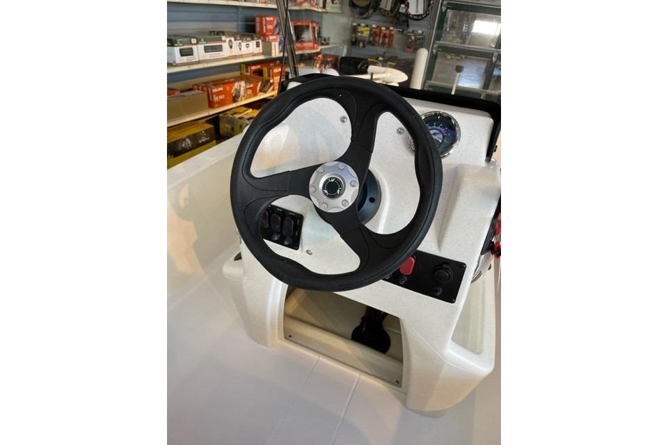 Steering console of 2026 Mako Pro Skiff 13 CC boat in showroom.
