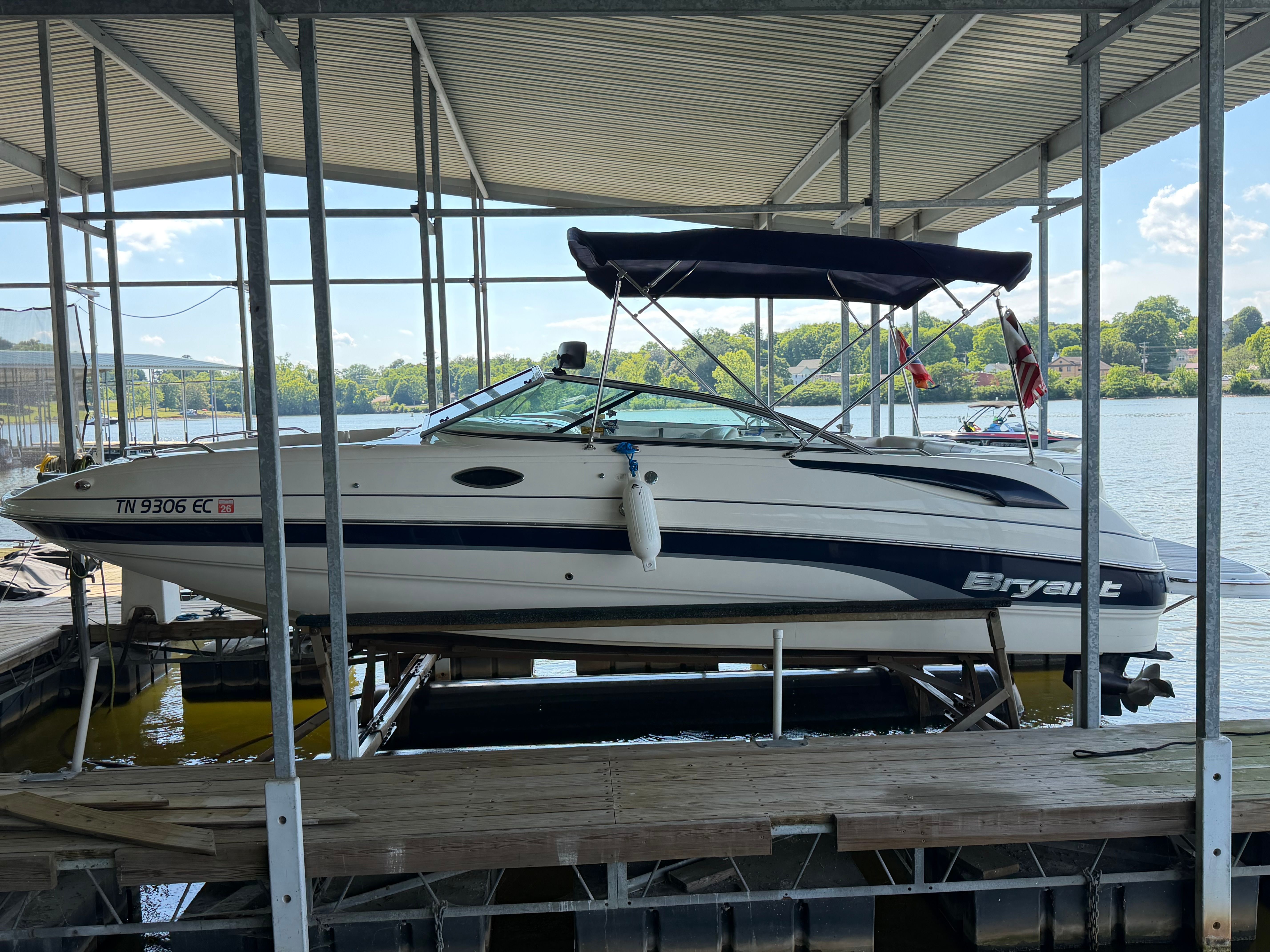 2010 Bryant 255 boat docked with canopy.