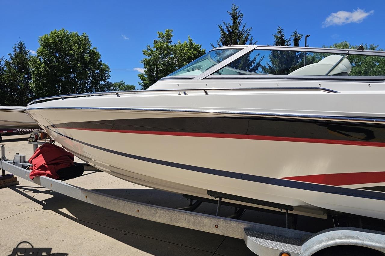 2005 Formula 271 FASTech boat on trailer, sleek design, white with red and black accents.