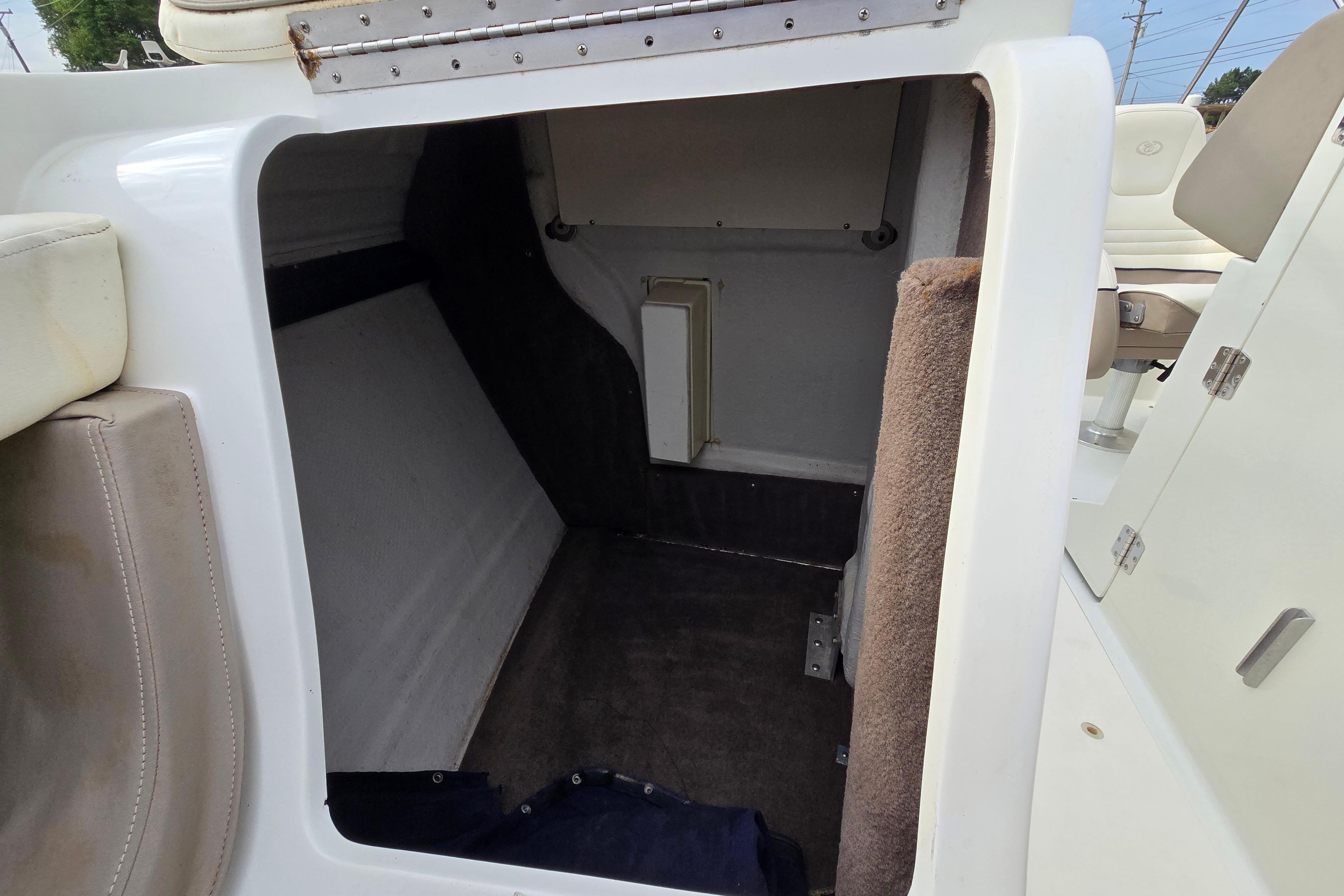 Interior cabin of a 2000 Cobalt 246 boat, featuring seating and storage space.
