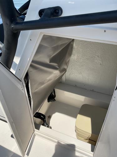 2025 Starcraft SVX 211 OB CC boat storage compartment with beige portable toilet.