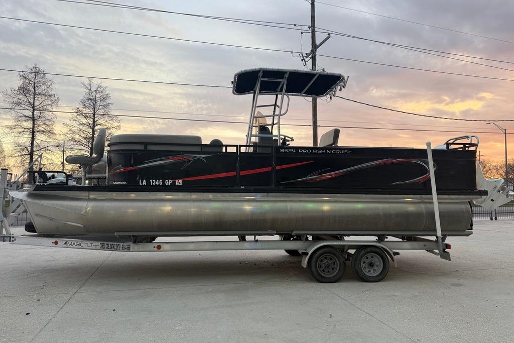 2022 Apex Marine 8524 Pro Fish N Cruise pontoon boat on trailer at sunset.