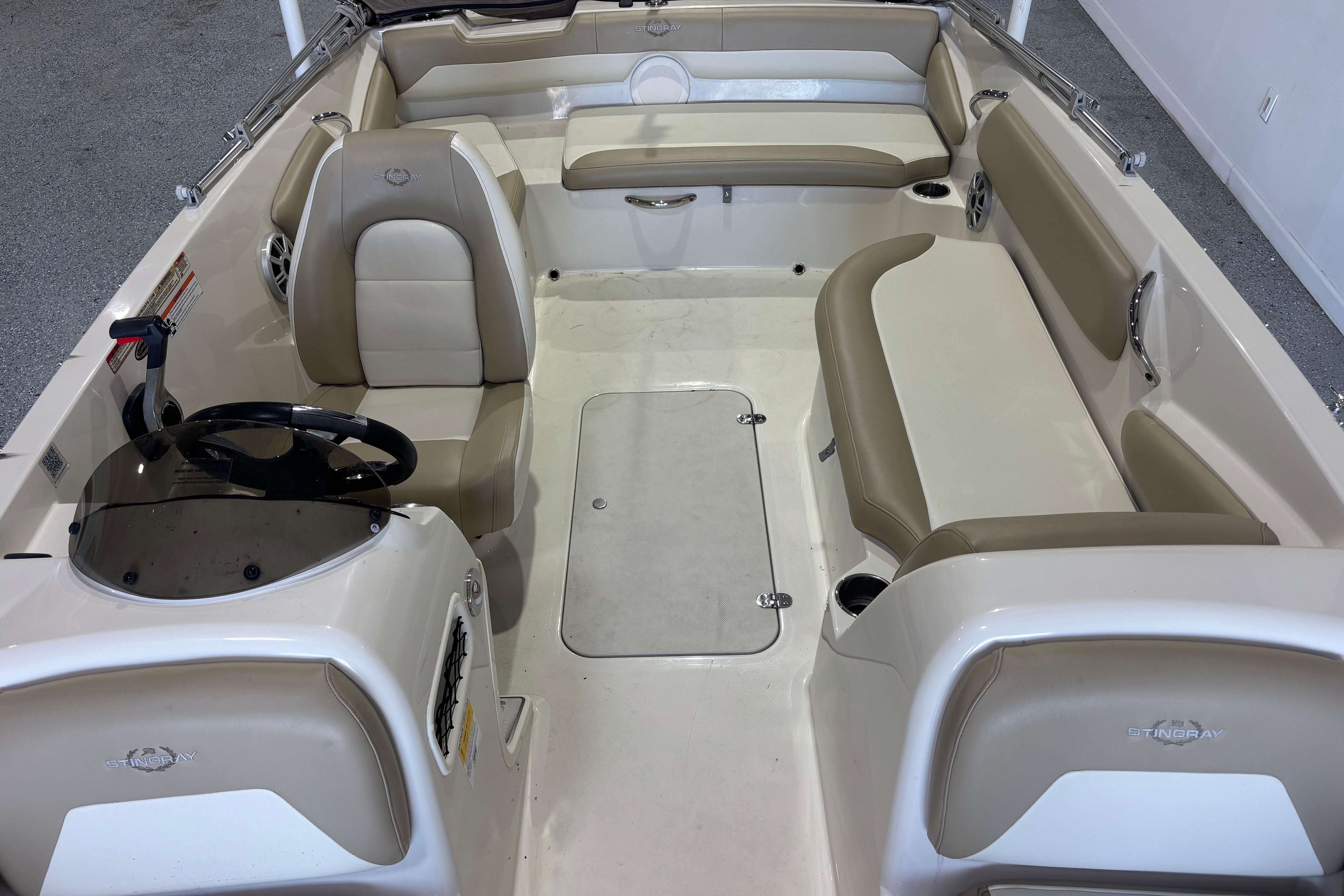 2017 Stingray 182 SC boat interior with beige seating and steering console.