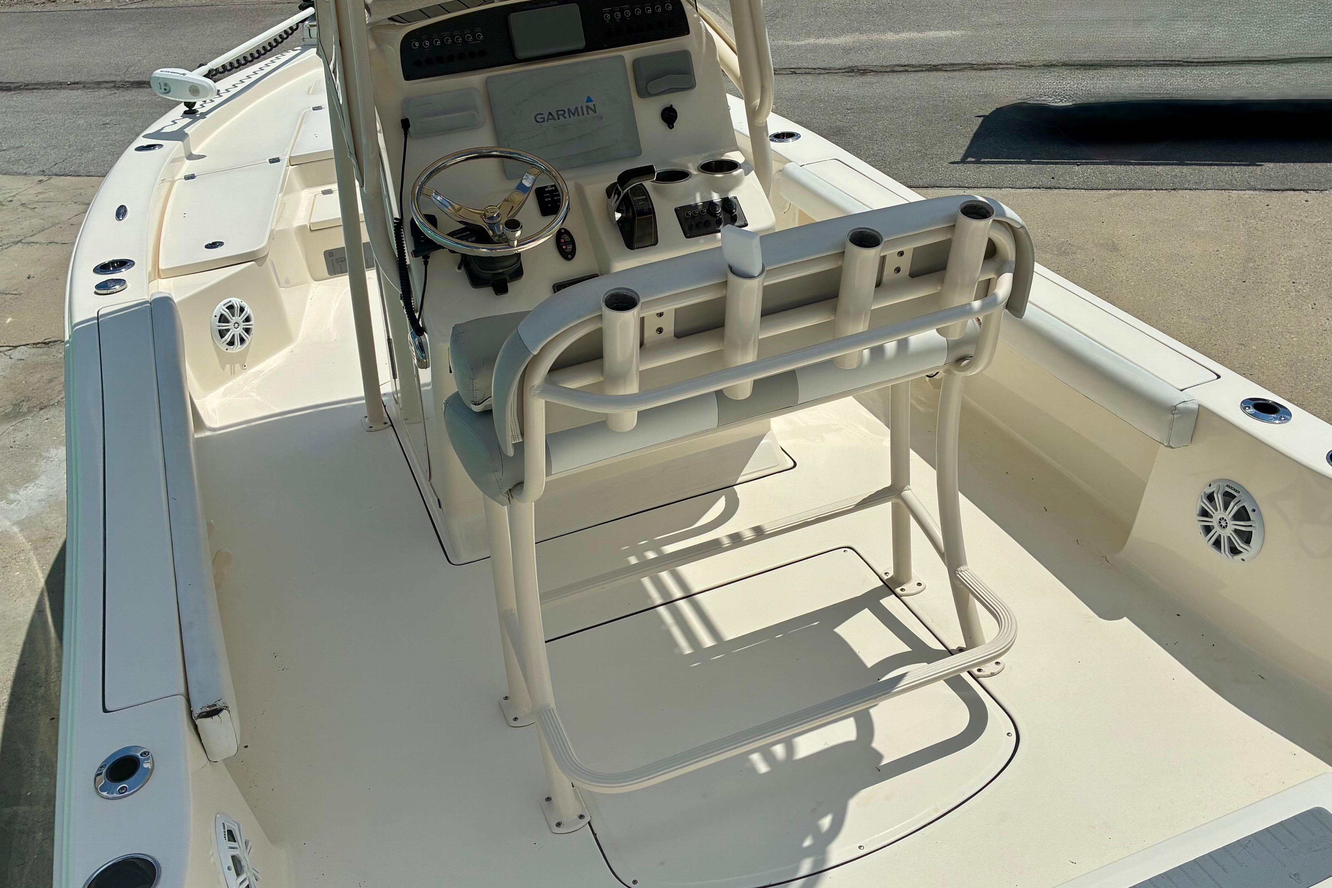 2018 Avenger AV24 boat interior with steering console and seating.