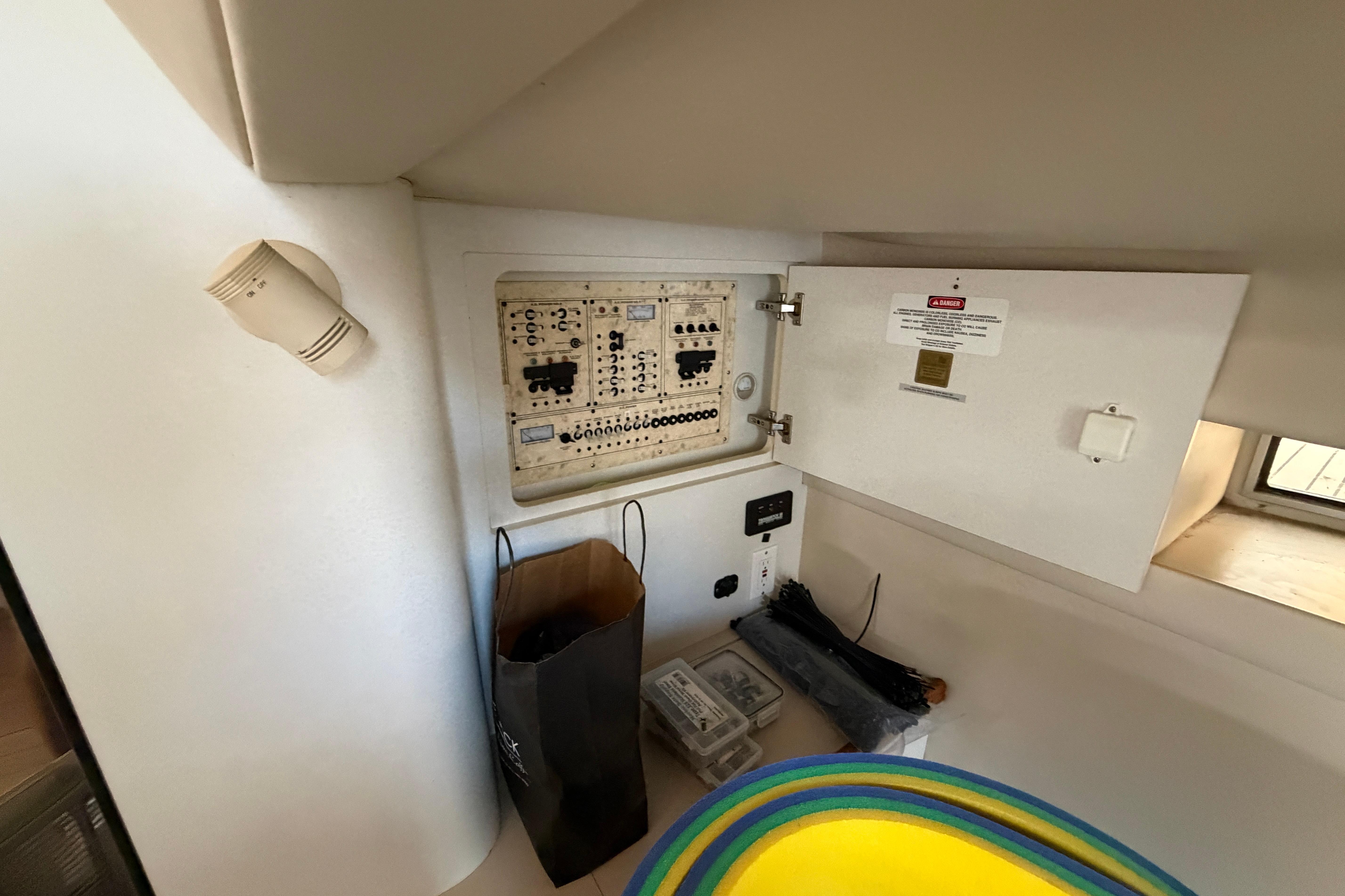 Electrical panel inside a 1997 Cruisers 3575 boat cabin with open access door.