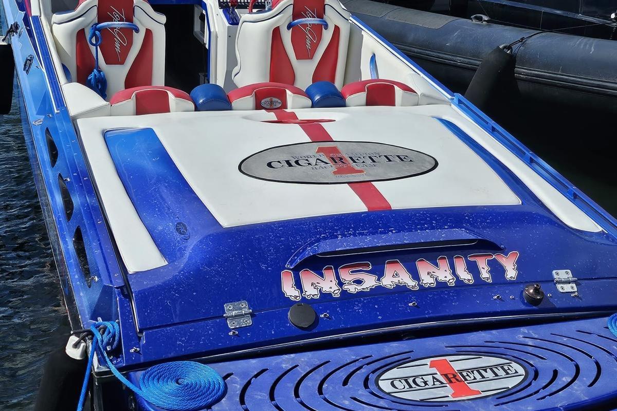 2004 Cigarette 38 Top Gun speedboat with "Insanity" branding, blue and white design.