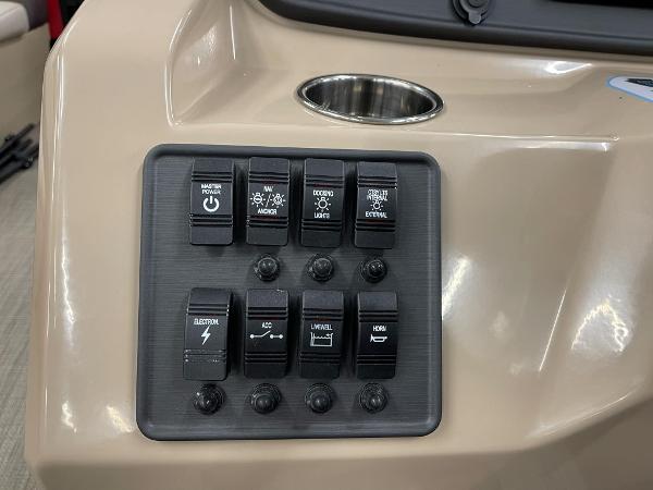 Control panel of 2025 Bentley Pontoons 200 Fish-N-Cruise with various switches and cup holder.