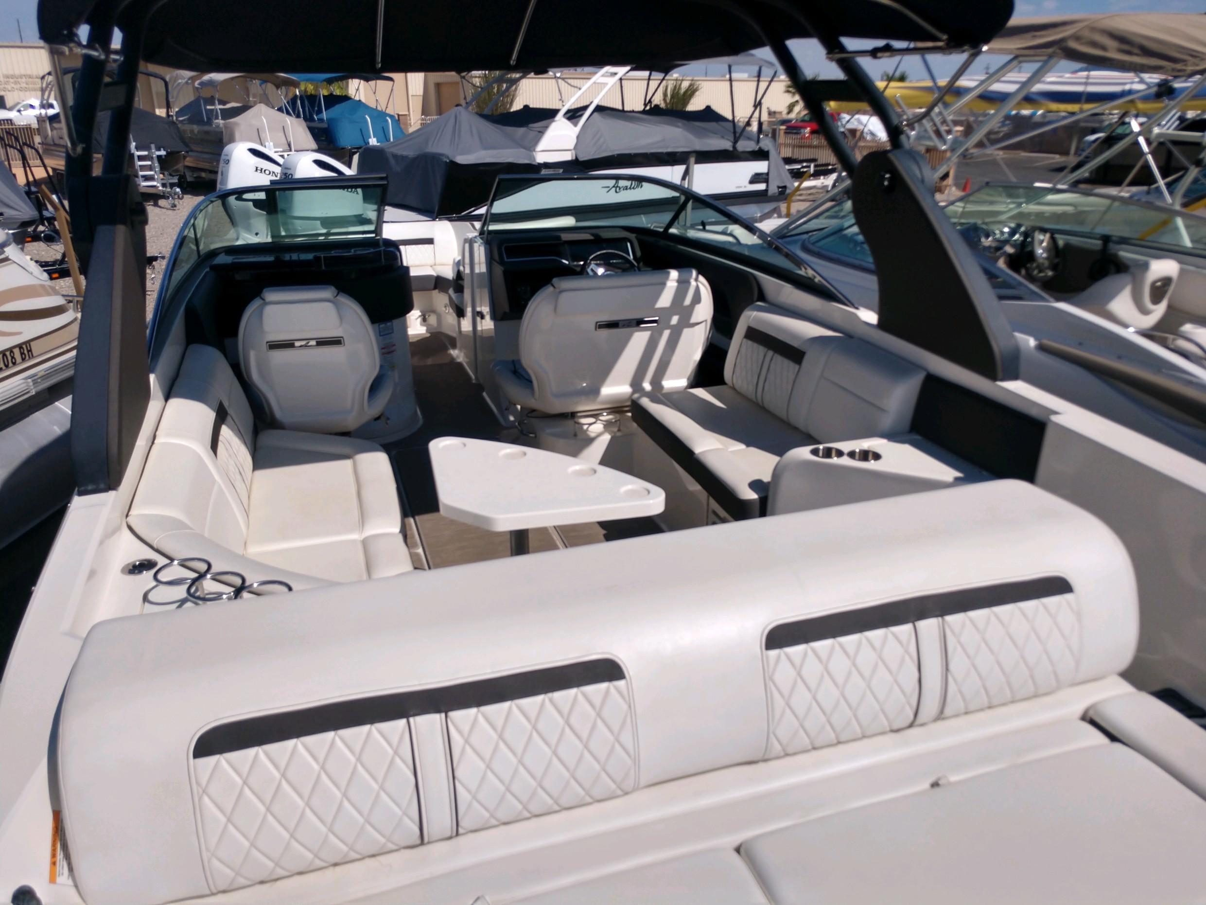 2018 Sea Ray SLX 280 boat interior with white seating and steering console.
