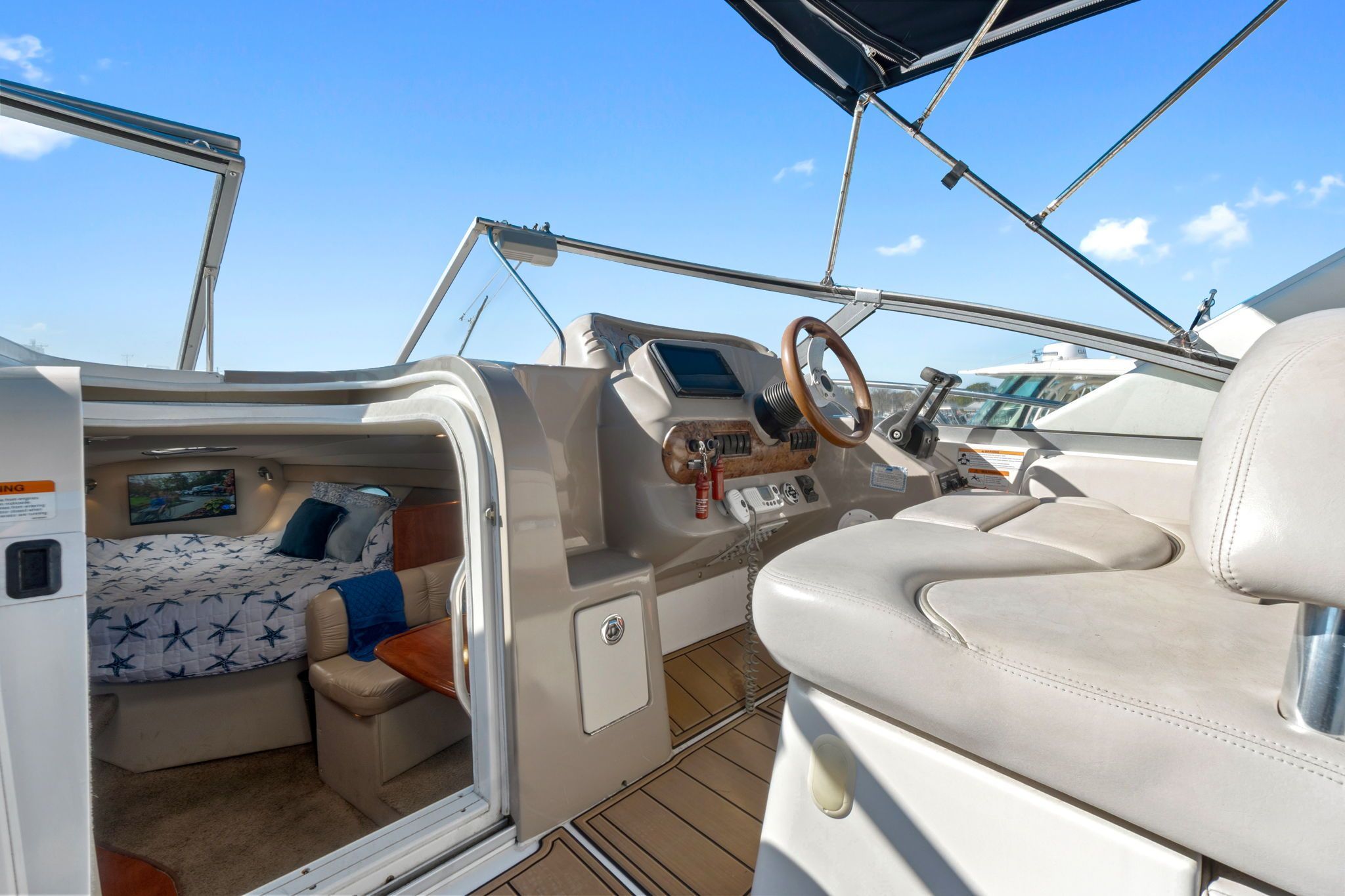 The image shows the cockpit and cabin of a 2007 Larson Cabrio 330.