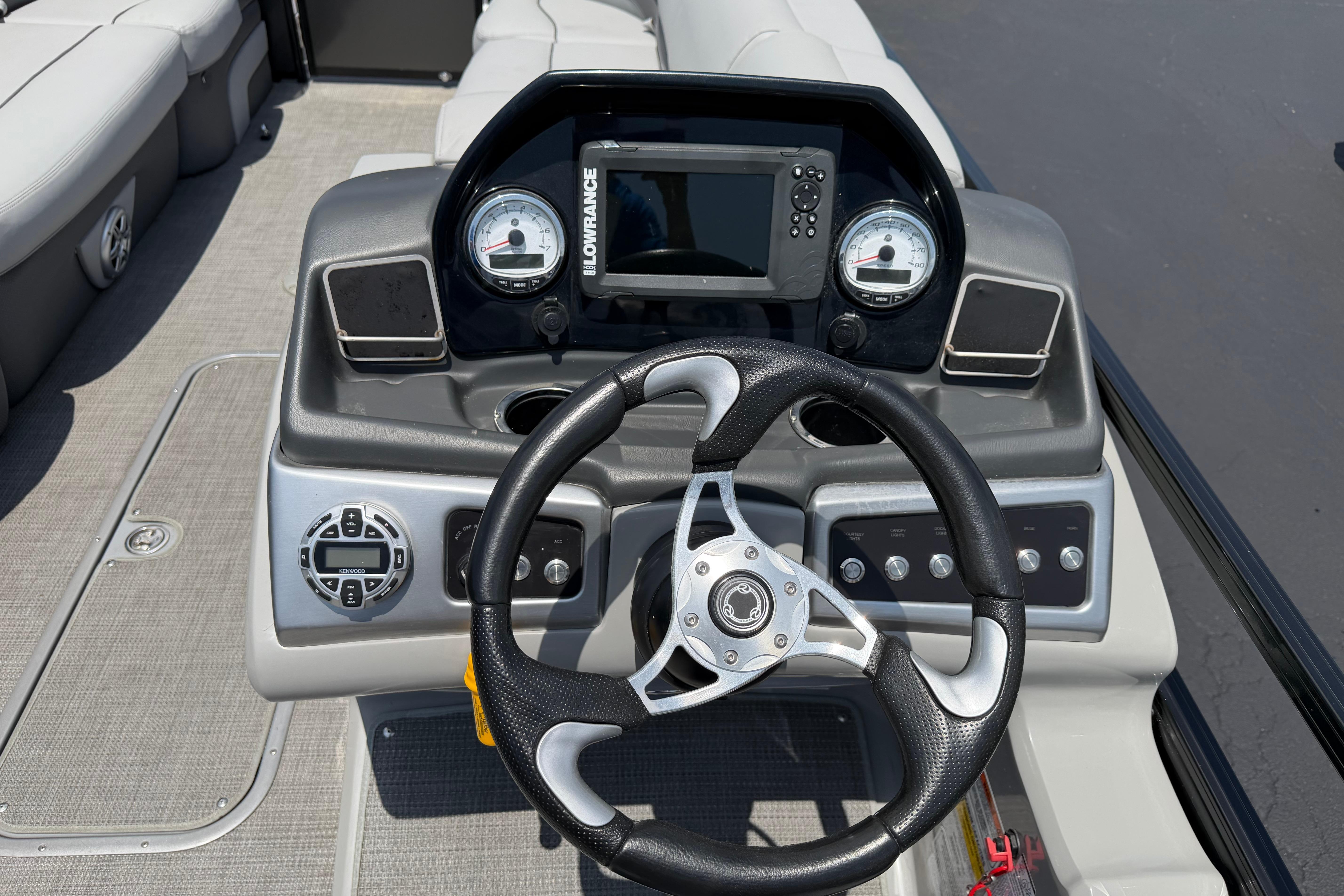 Steering console of 2019 Regency 230 DL3 boat with gauges and controls.
