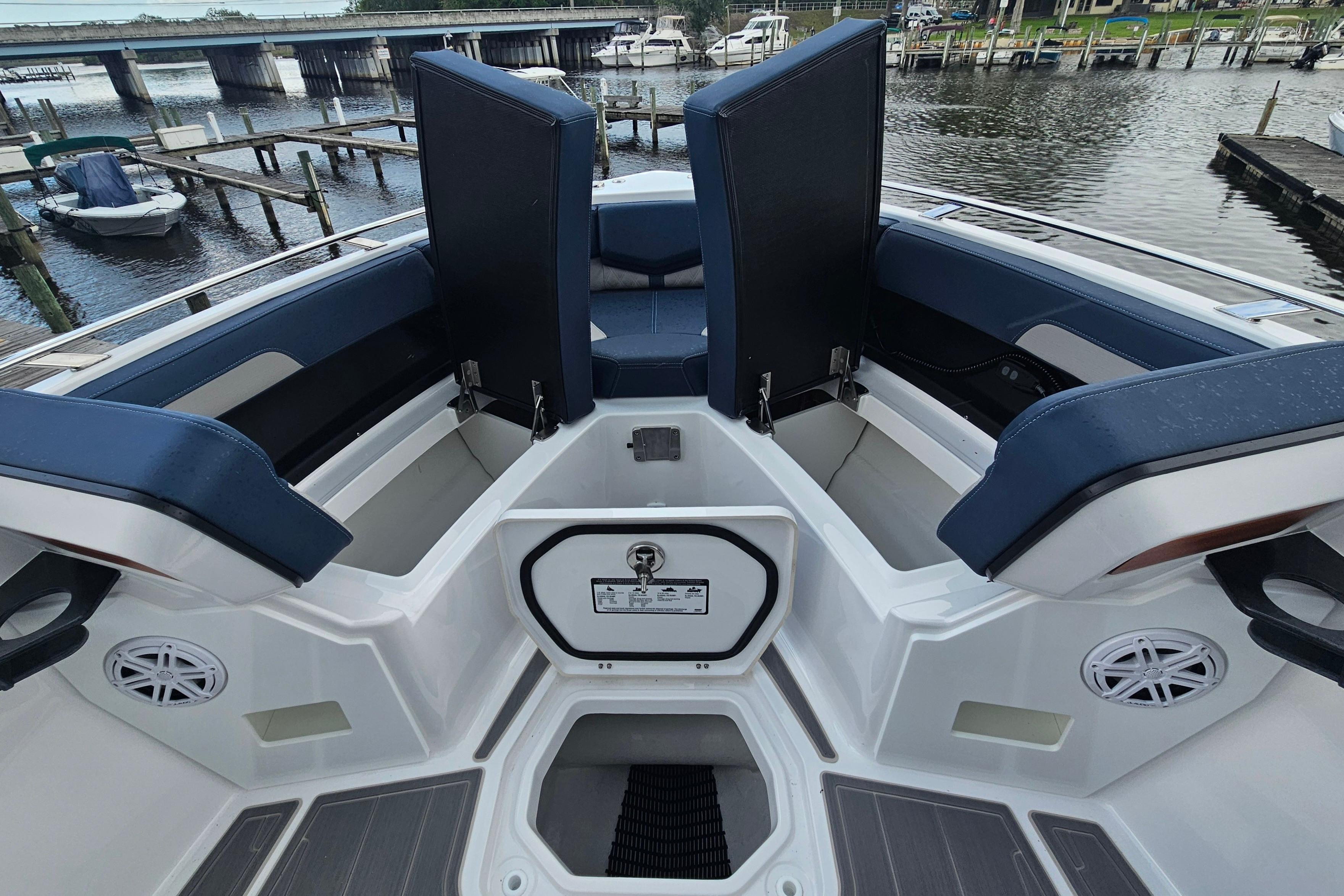 2026 Monterey Elite 27 OB boat interior with open storage compartments and seating.
