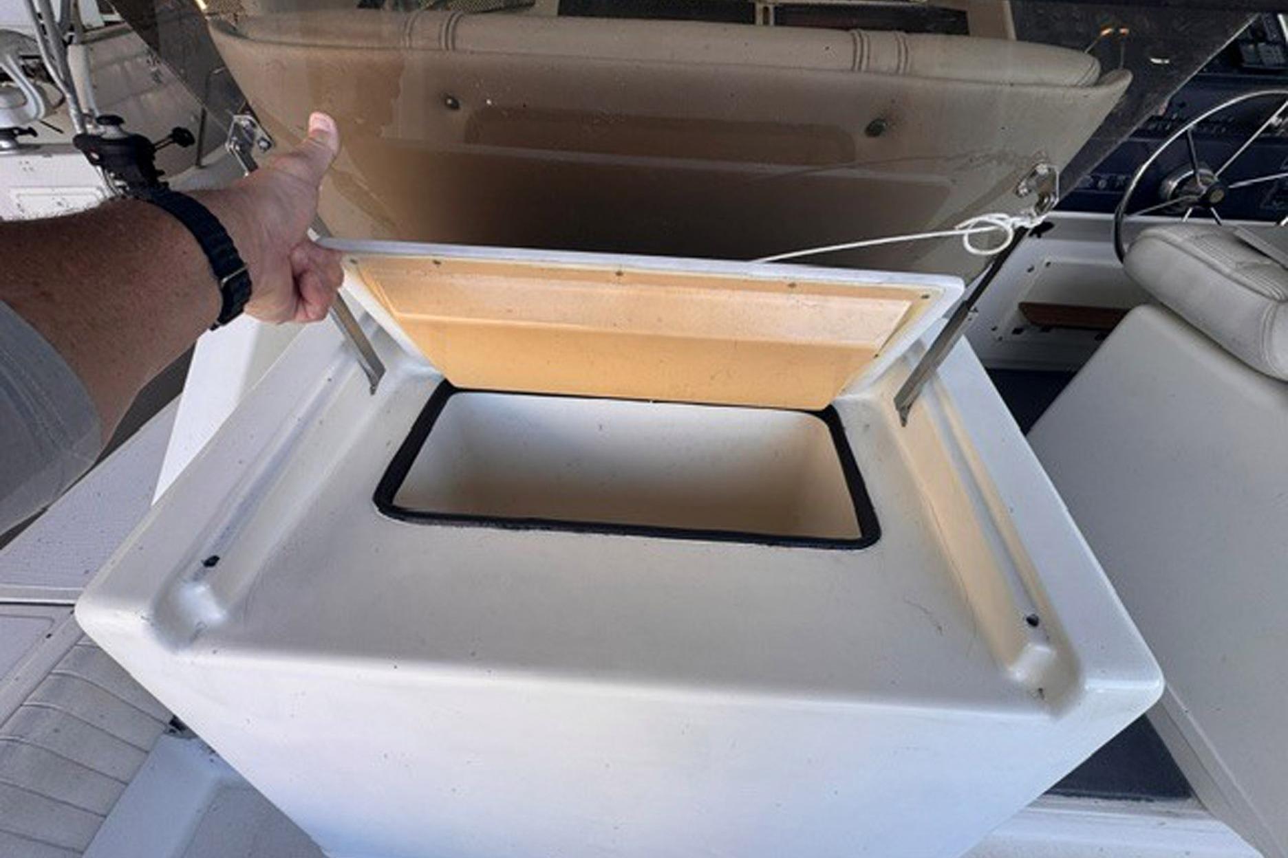 1988 Tiara Yachts 3300 Open storage compartment with open lid, showcasing interior space.