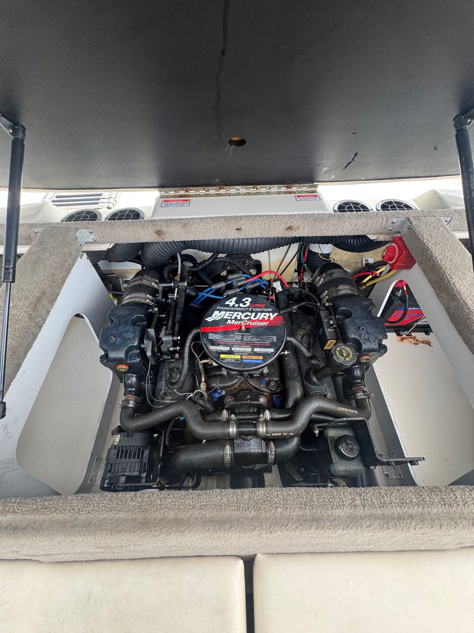 The engine compartment of a 2005 Sea Ray 185 Sport features a 4.3-liter Mercury engine.