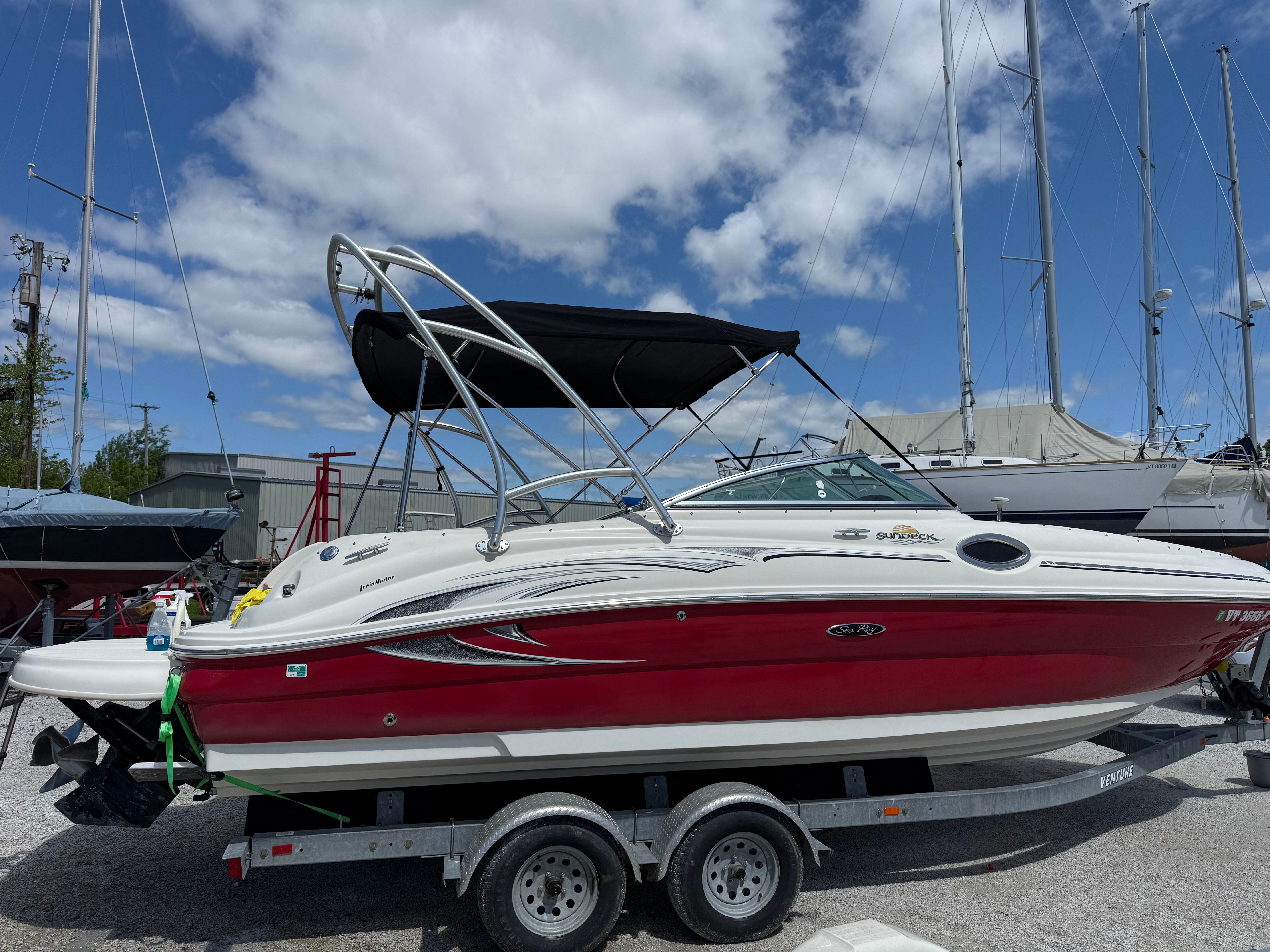 2005 Sea Ray 240 Sundeck boat on trailer at marina.