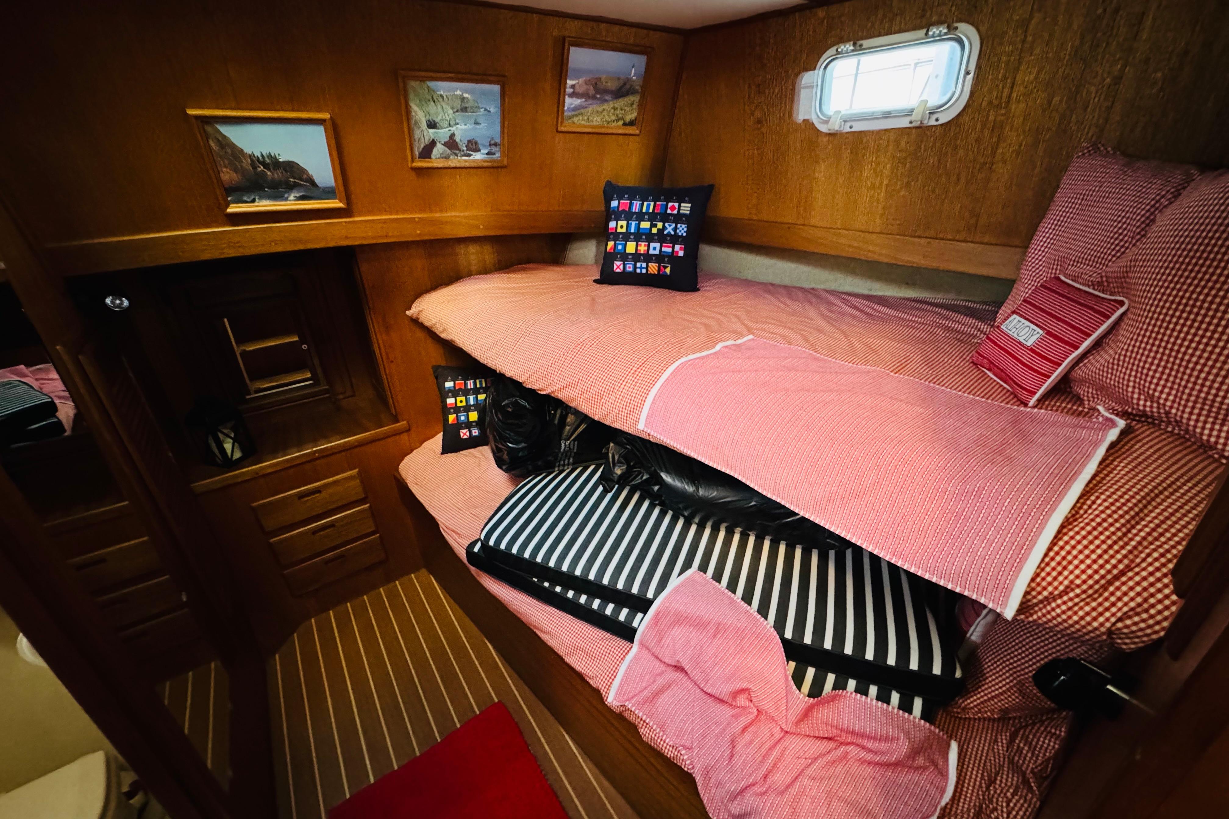 Cozy cabin interior of 1978 Californian 42 LRC with bunk beds and nautical decor.