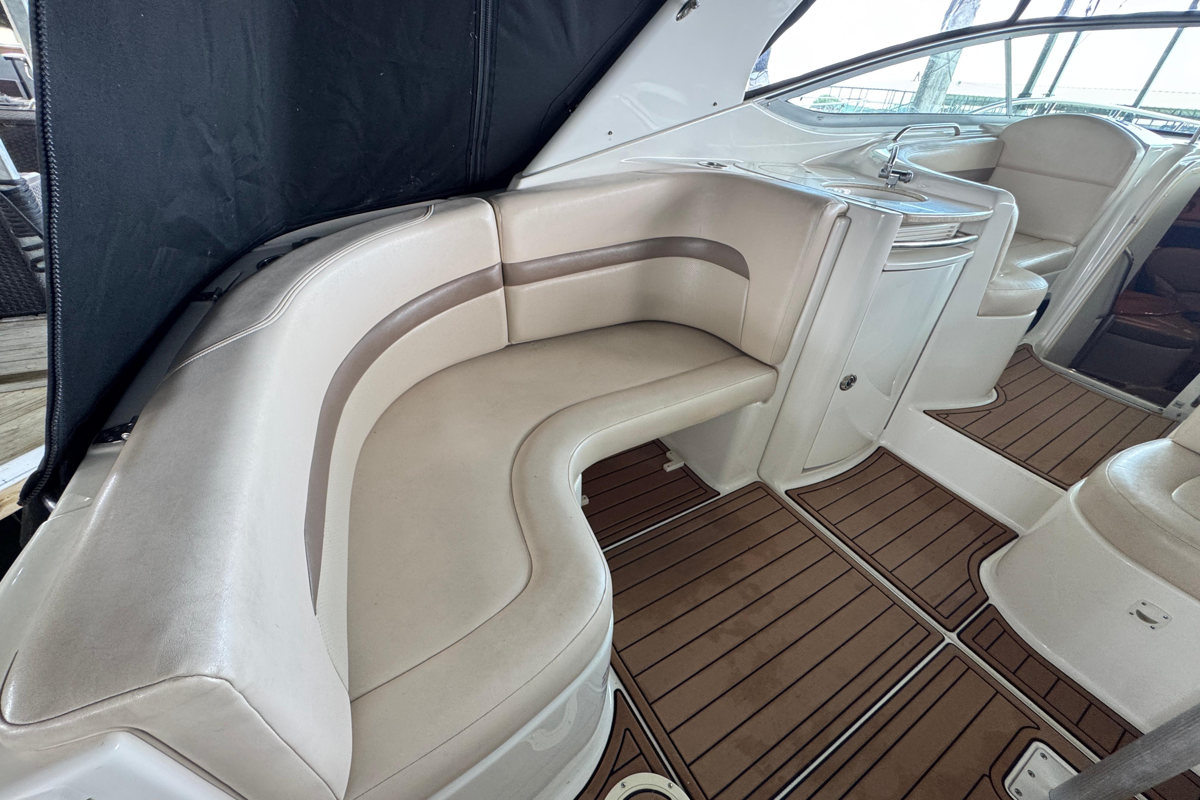 2006 Chaparral 330 Signature boat interior with beige seating and wood flooring.