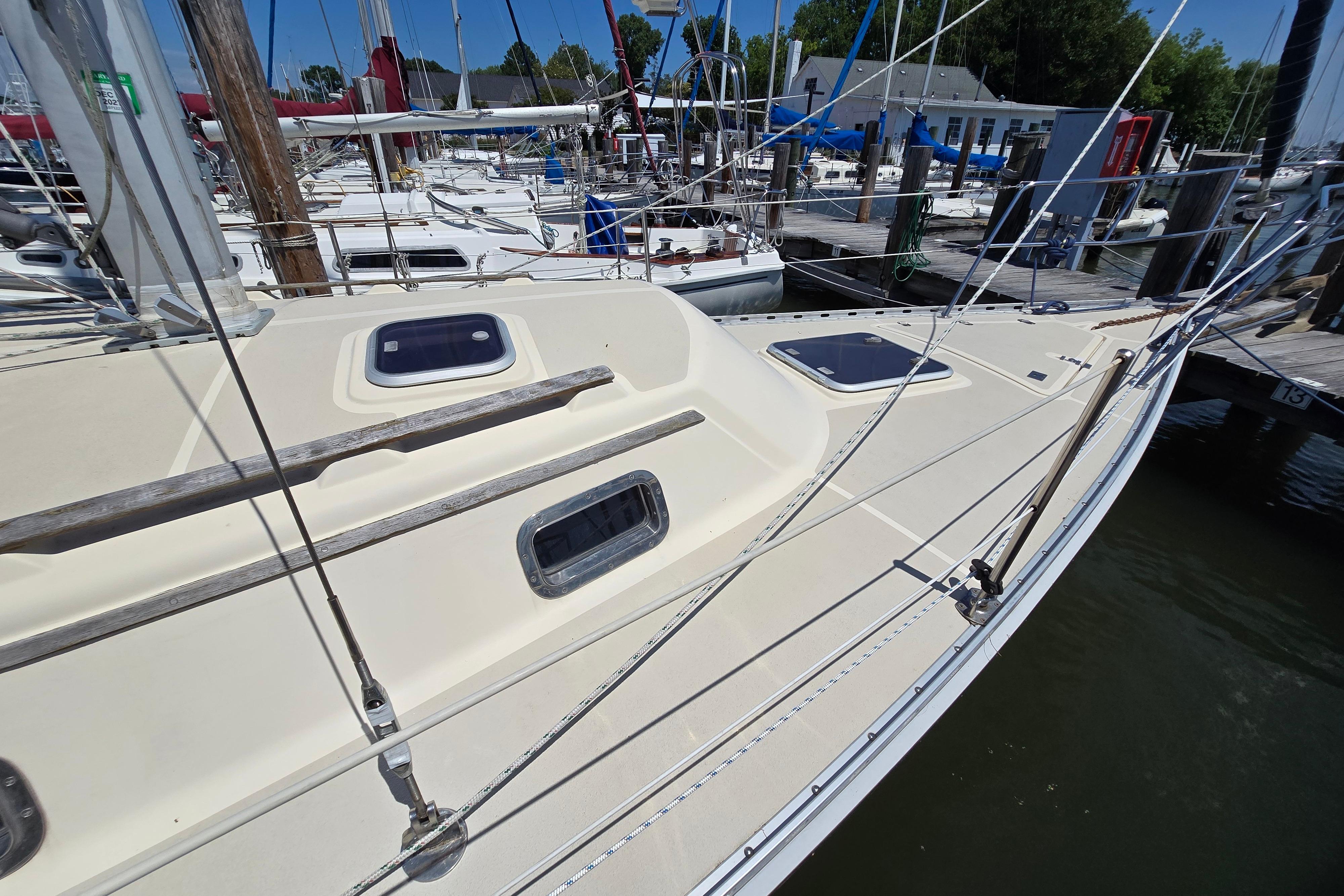 Sailboat docked at marina, 1993 Caliber 35 model, with visible deck and rigging.