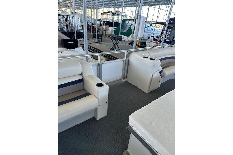 2008 Destination Yachts 45X14 interior with white seating and cup holders in a marina.