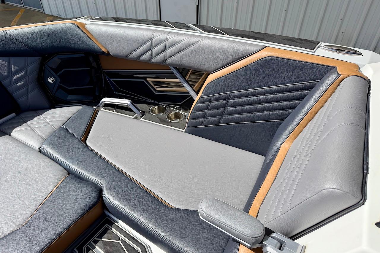 Luxurious interior of 2025 Tigé Ultré 25ZX boat with stylish seating and cup holders.