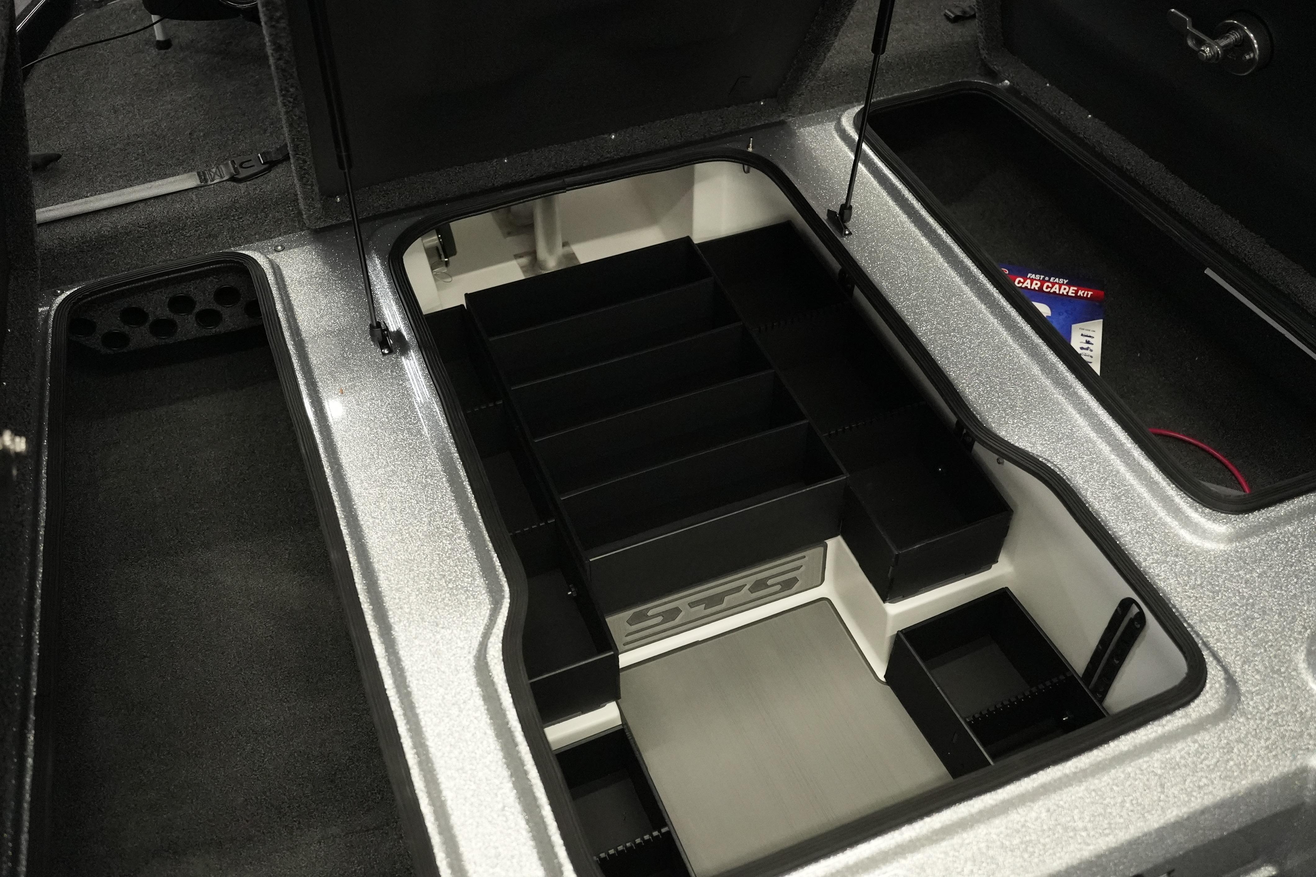 2026 Bass Cat Lynx STS storage compartment with organized sections and car care kit.