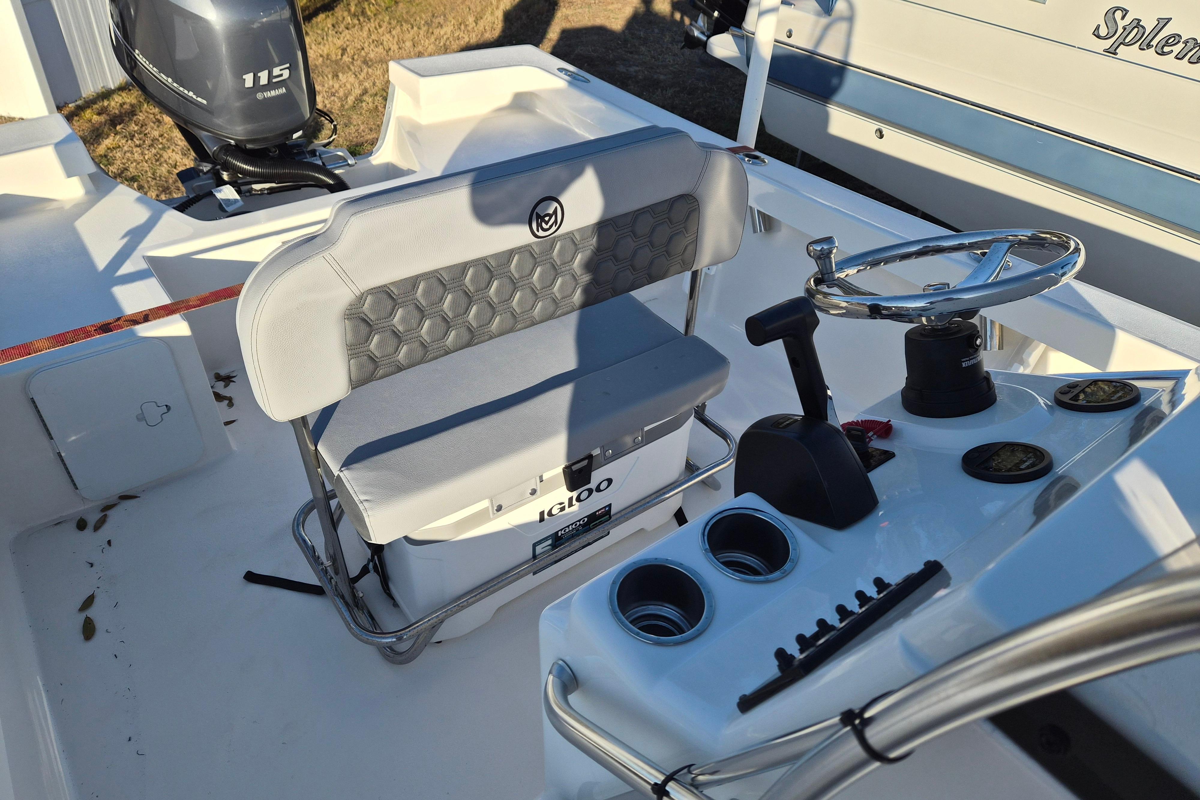 2026 May-Craft 192 boat interior with steering wheel, seating, and Yamaha 115 outboard motor.