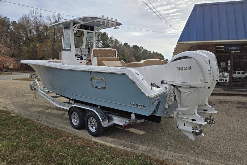 2026 Sea Hunt Ultra 275 Coffin Box boat on trailer, dual Yamaha engines, parked outdoors.