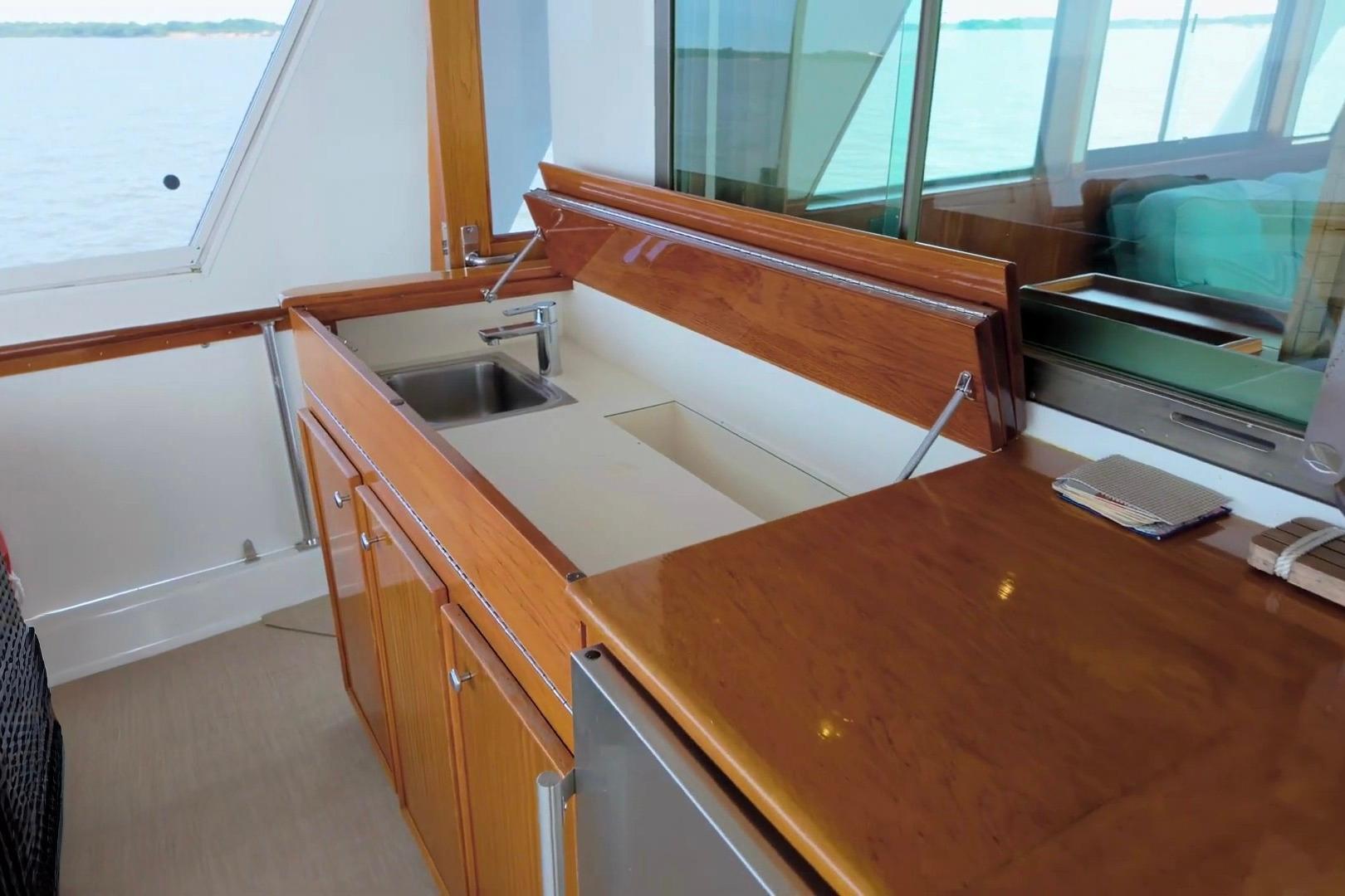 1980 Hatteras 70 Motor Yacht interior with wooden cabinetry and sink.