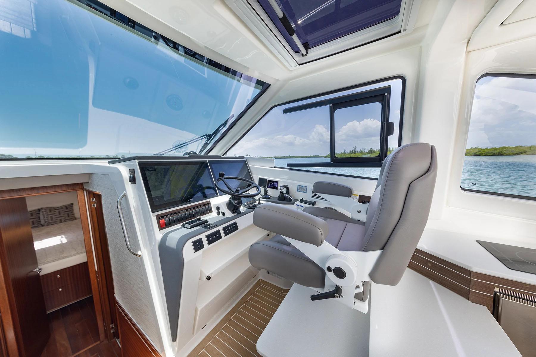 Manufacturer Provided Image: 2025 Pursuit OS 445 Offshore helm with modern controls and panoramic windows.