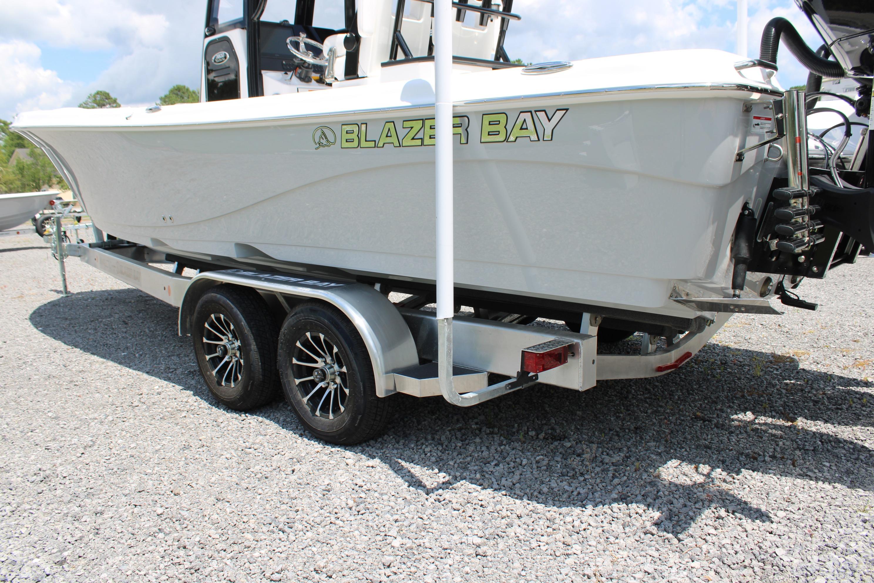 2027 Blazer Bay Makaira 2800 boat on trailer, side view, outdoors.