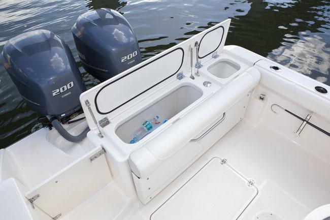Manufacturer Provided Image: 2013 Pursuit C 260 Center Console boat with twin 200 horsepower engines and open storage compartment.