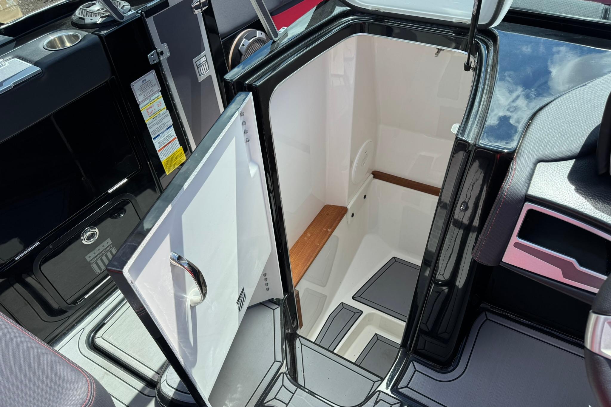 2021 MasterCraft X26 boat interior with open storage compartment.