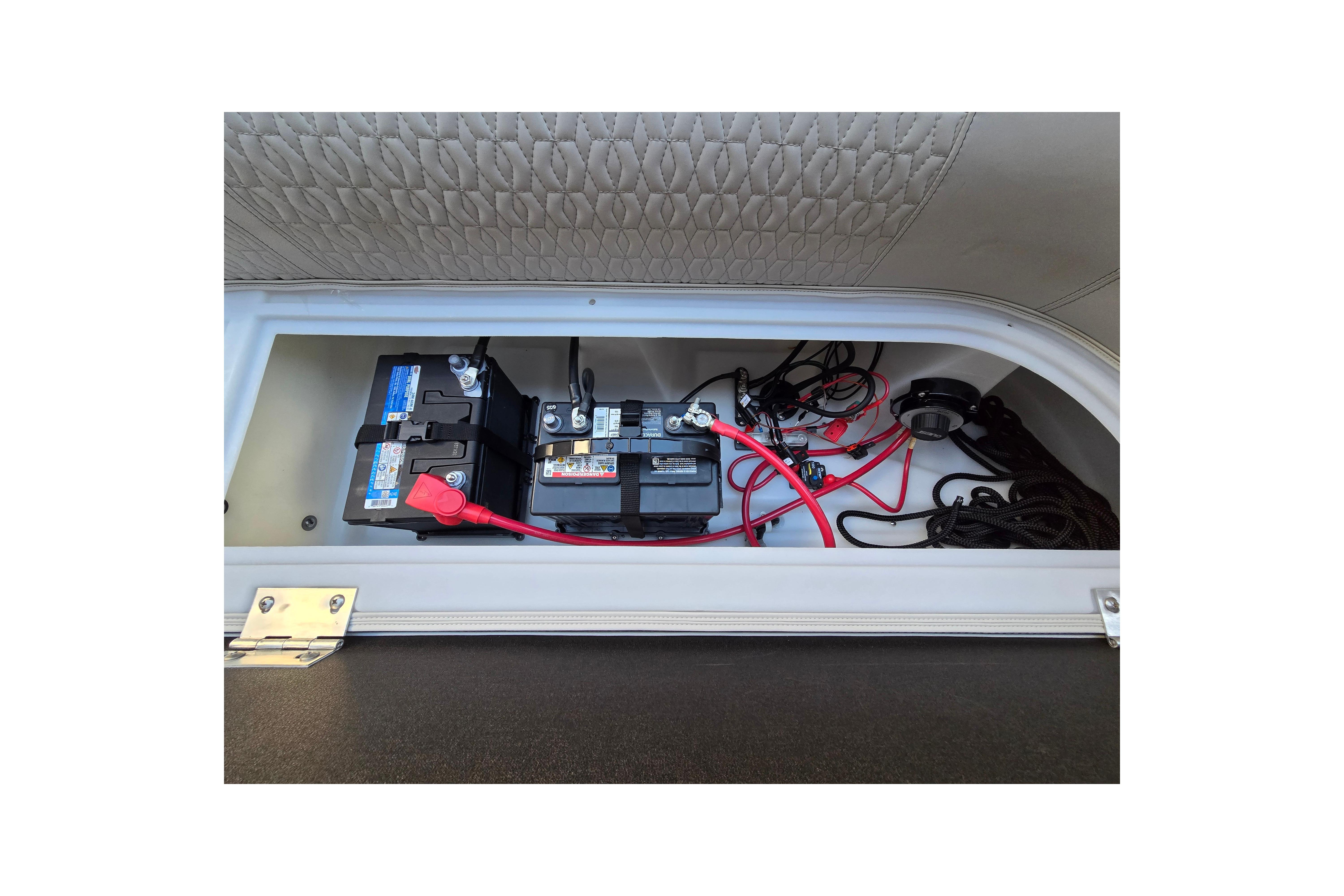 2024 Godfrey Sweetwater 2486 SB battery compartment with wiring and connections.