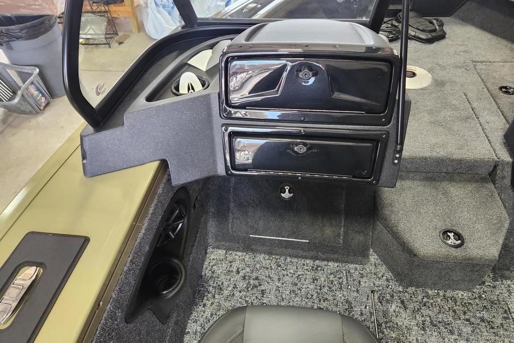 2026 Tracker Targa 185 WT boat interior with storage compartments and carpeted flooring.