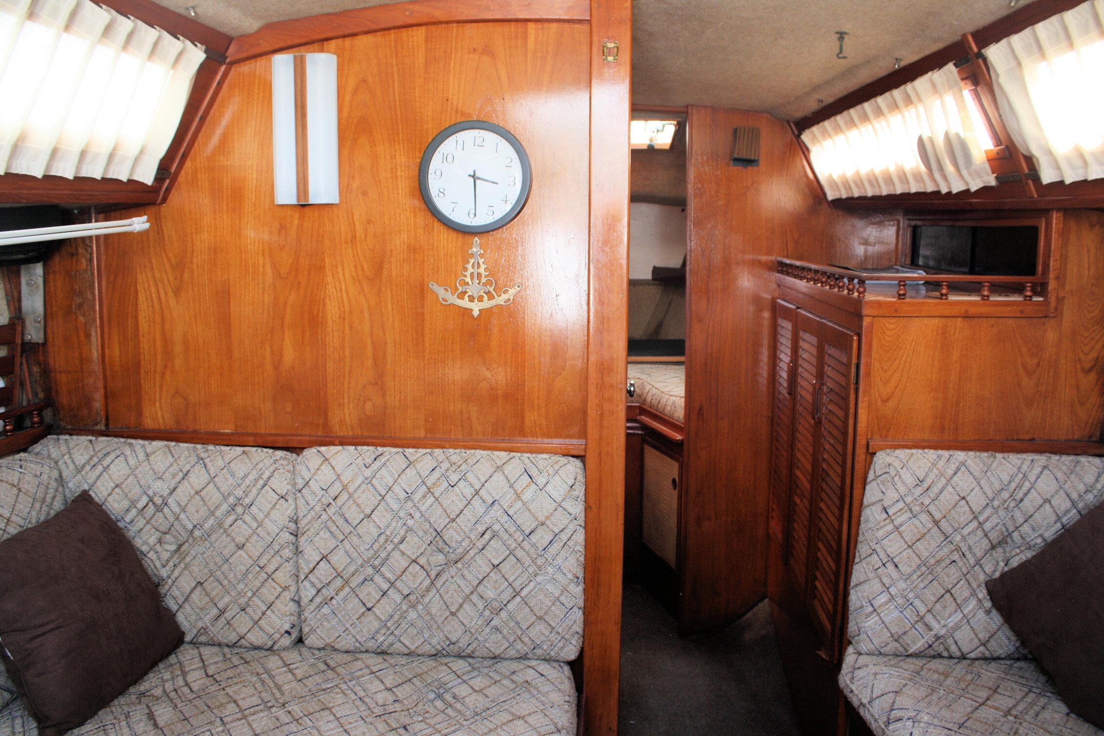 Interior of 1981 S2 9.2A sailboat with wood paneling and cushioned seating.