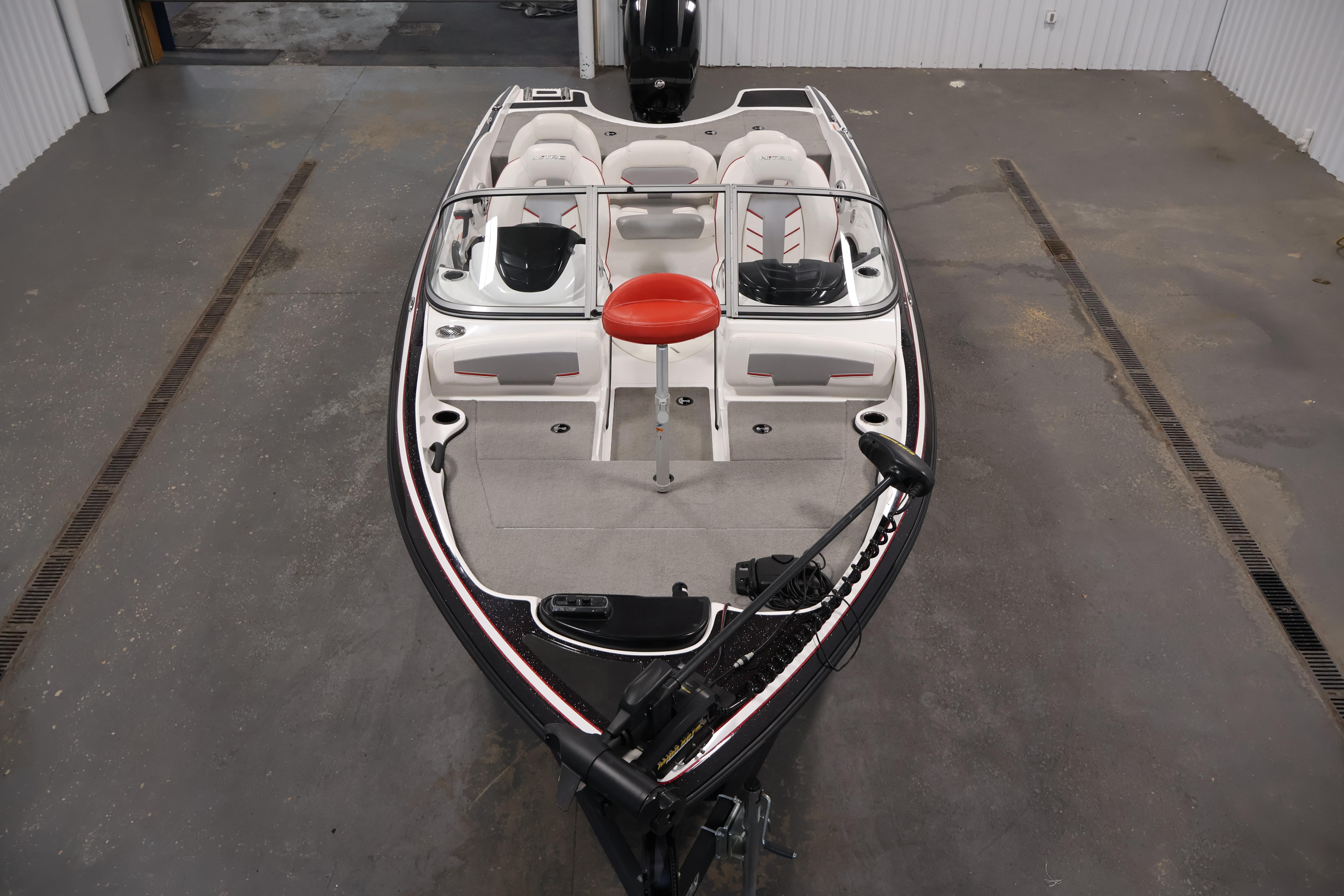2019 Nitro Z19 Sport boat in a garage, featuring seating and steering console.